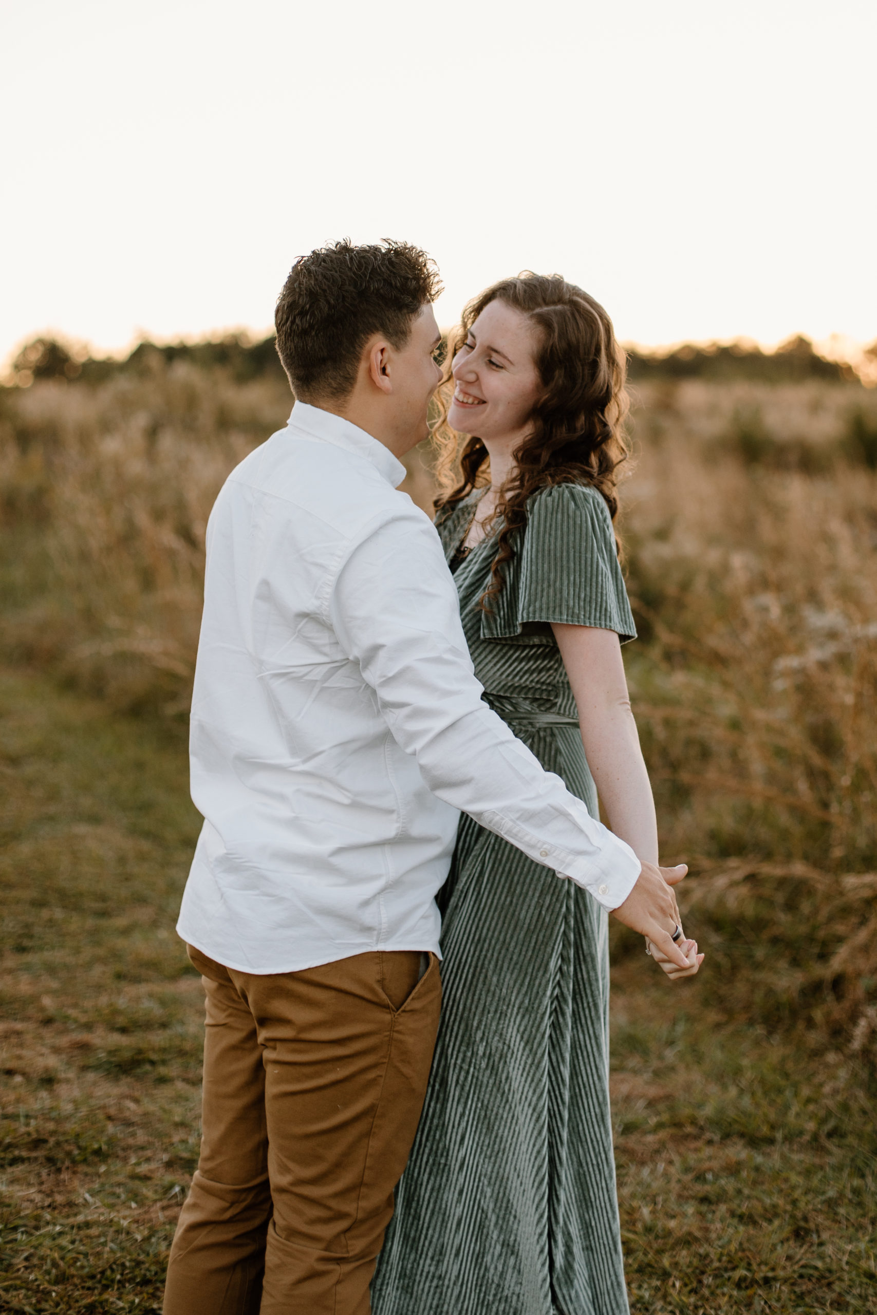 Beautiful couple pose romantically during their dreamy golden hour Georgia engagement photos
