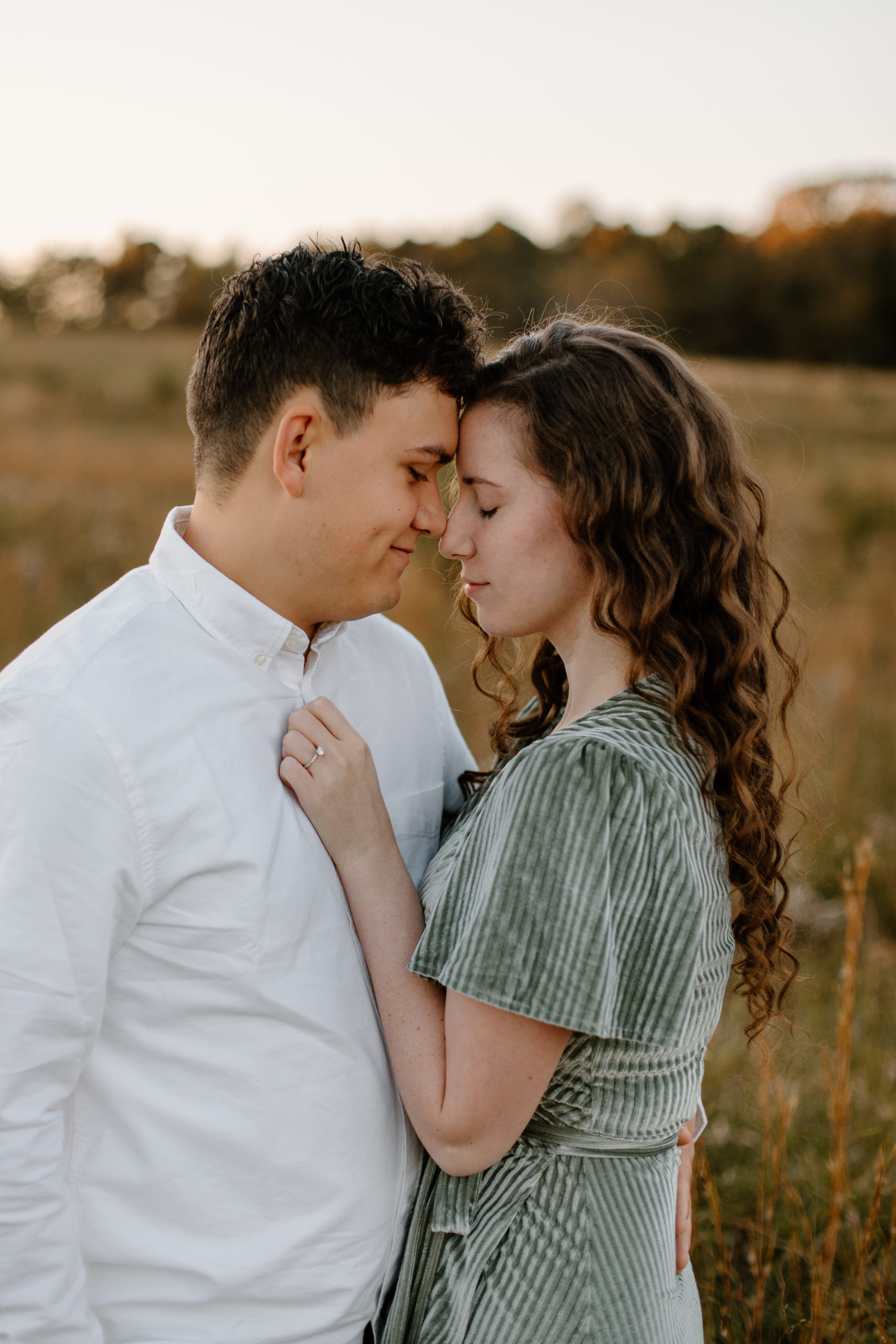 stunning couple pose forehead to forehead during their romantic Georgia engagement photoshoot