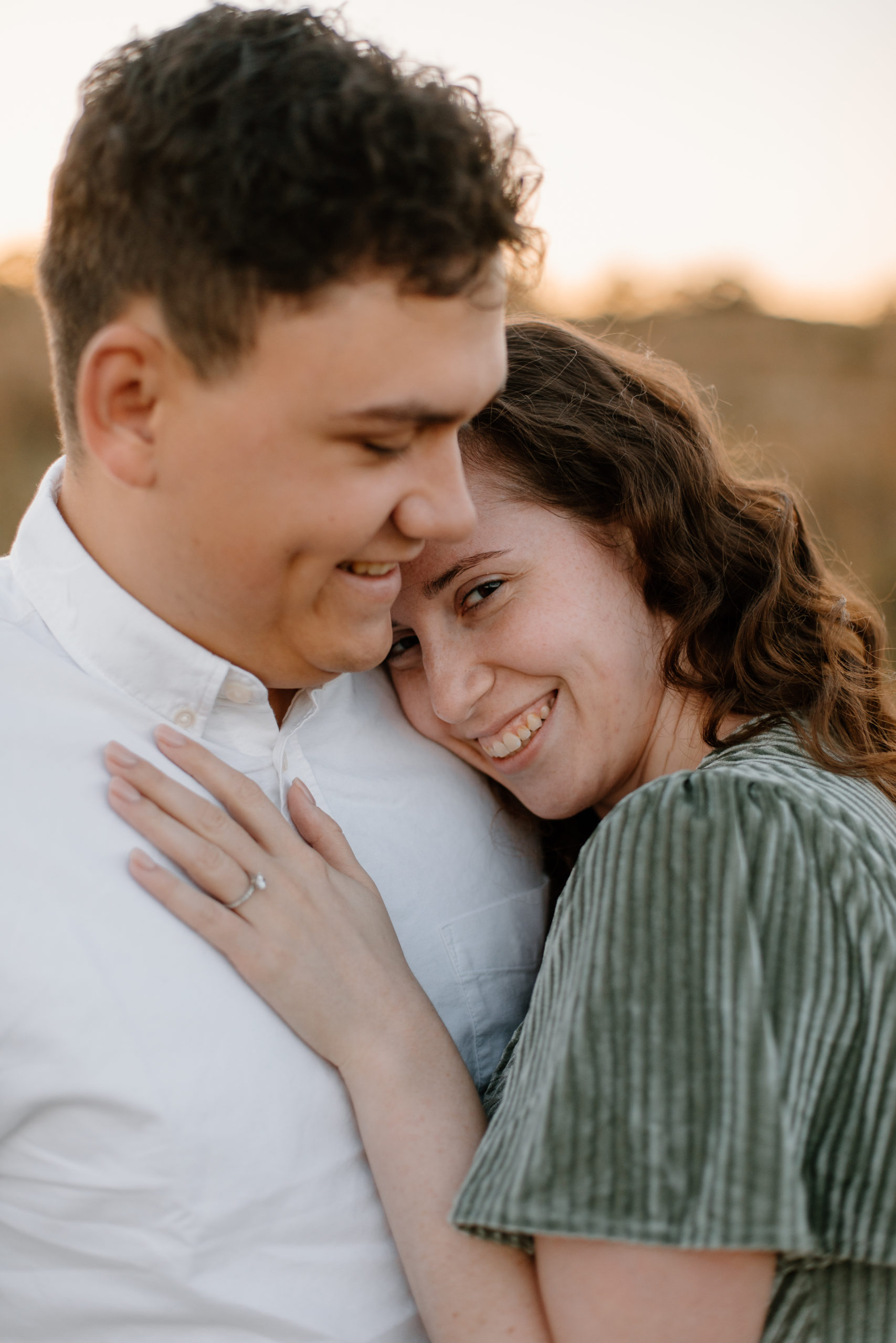 couple poses romantically during their Golden hour Georgia engagement photos