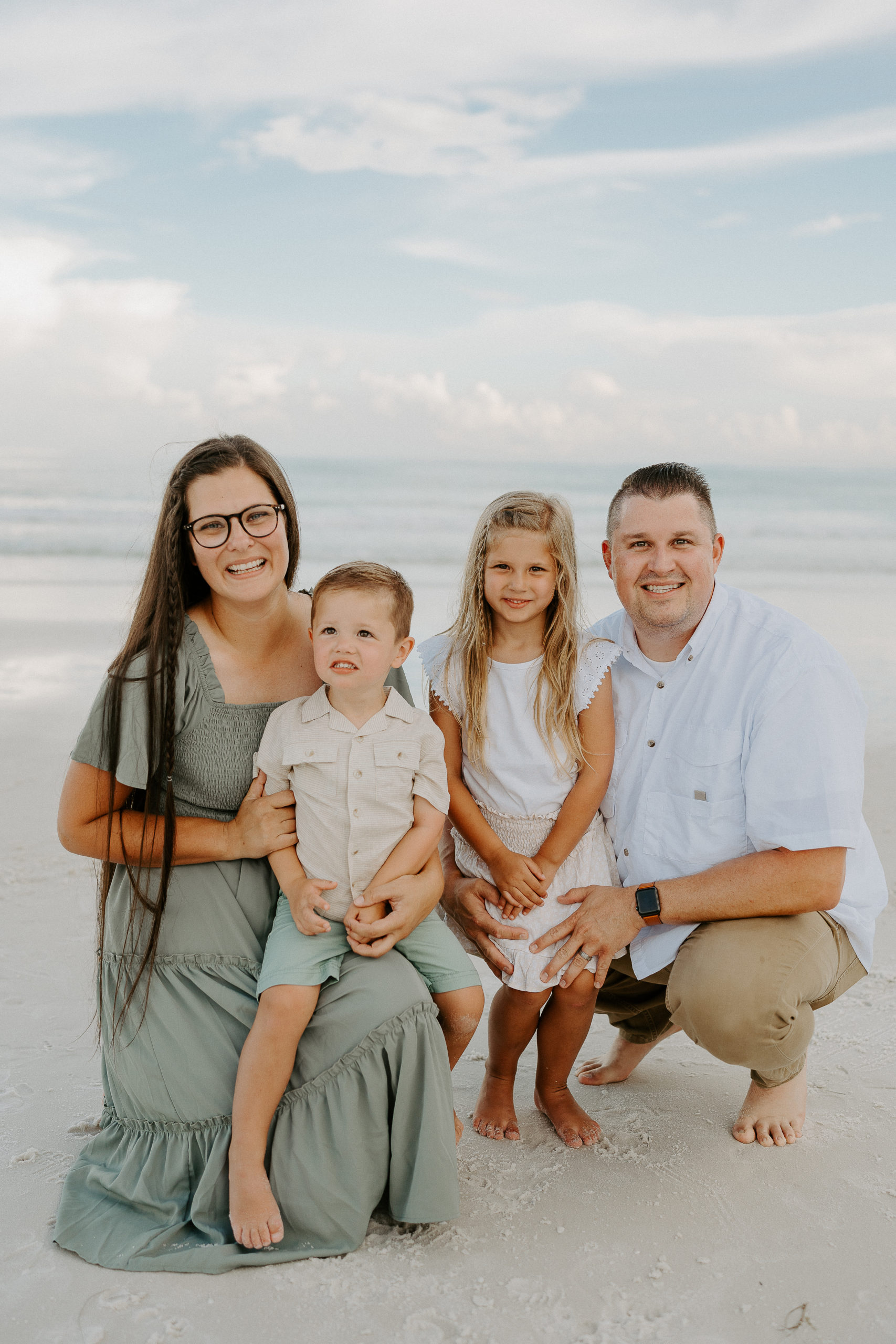 Rachel poses with her family on the beach