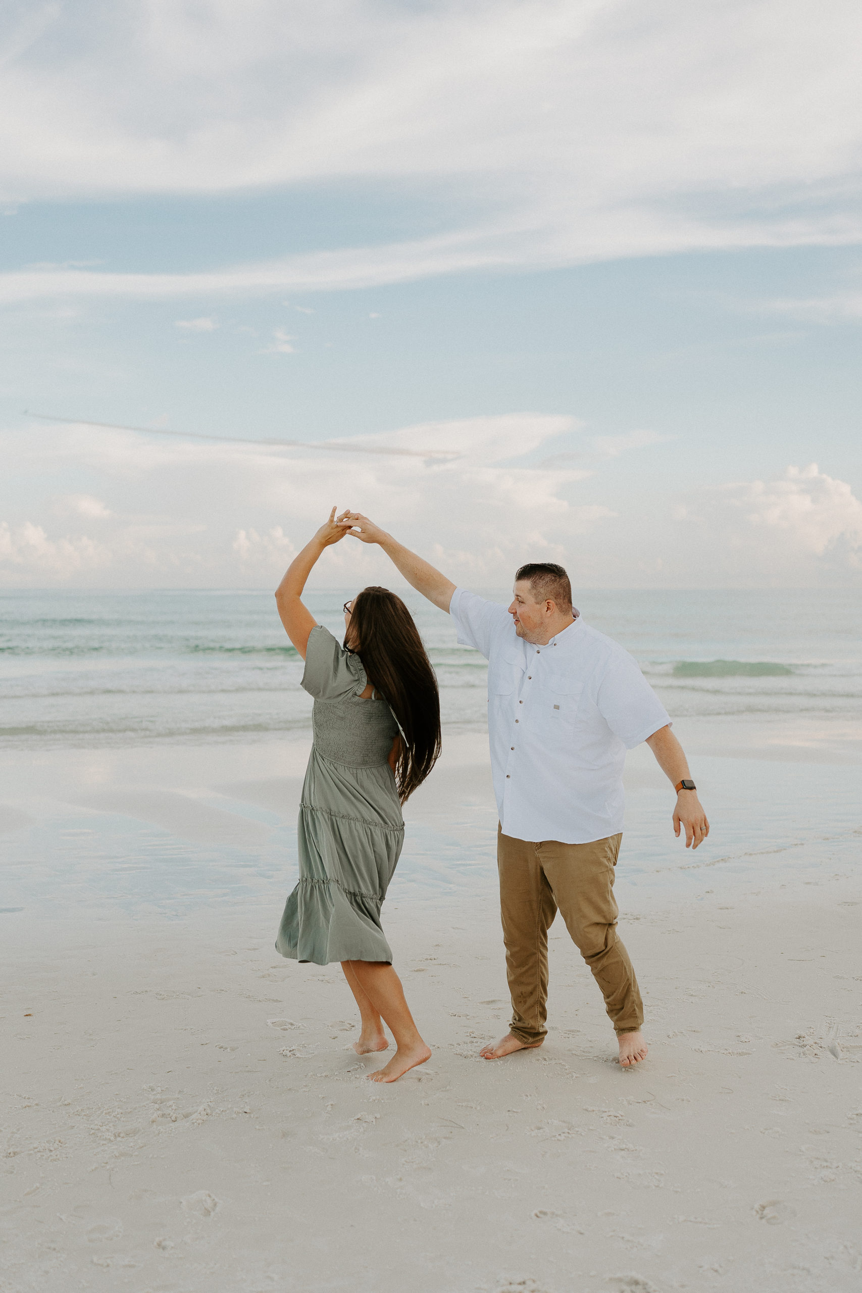 Rachel and her husband pose for a photo on the beach