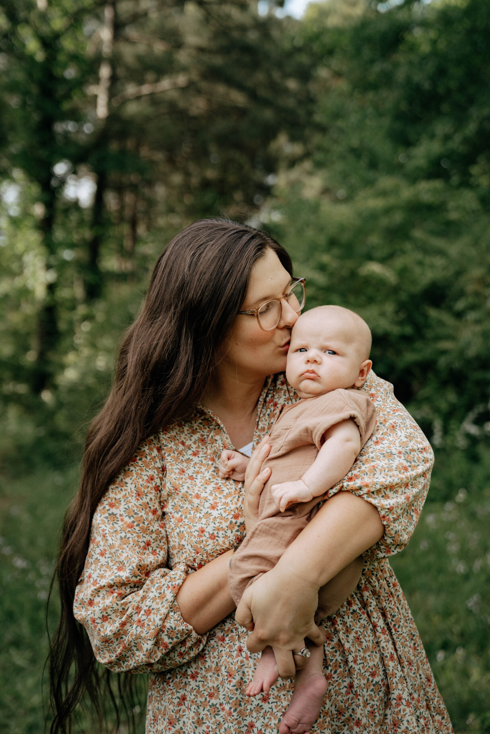 atlanta wedding photographer poses with her newborn baby