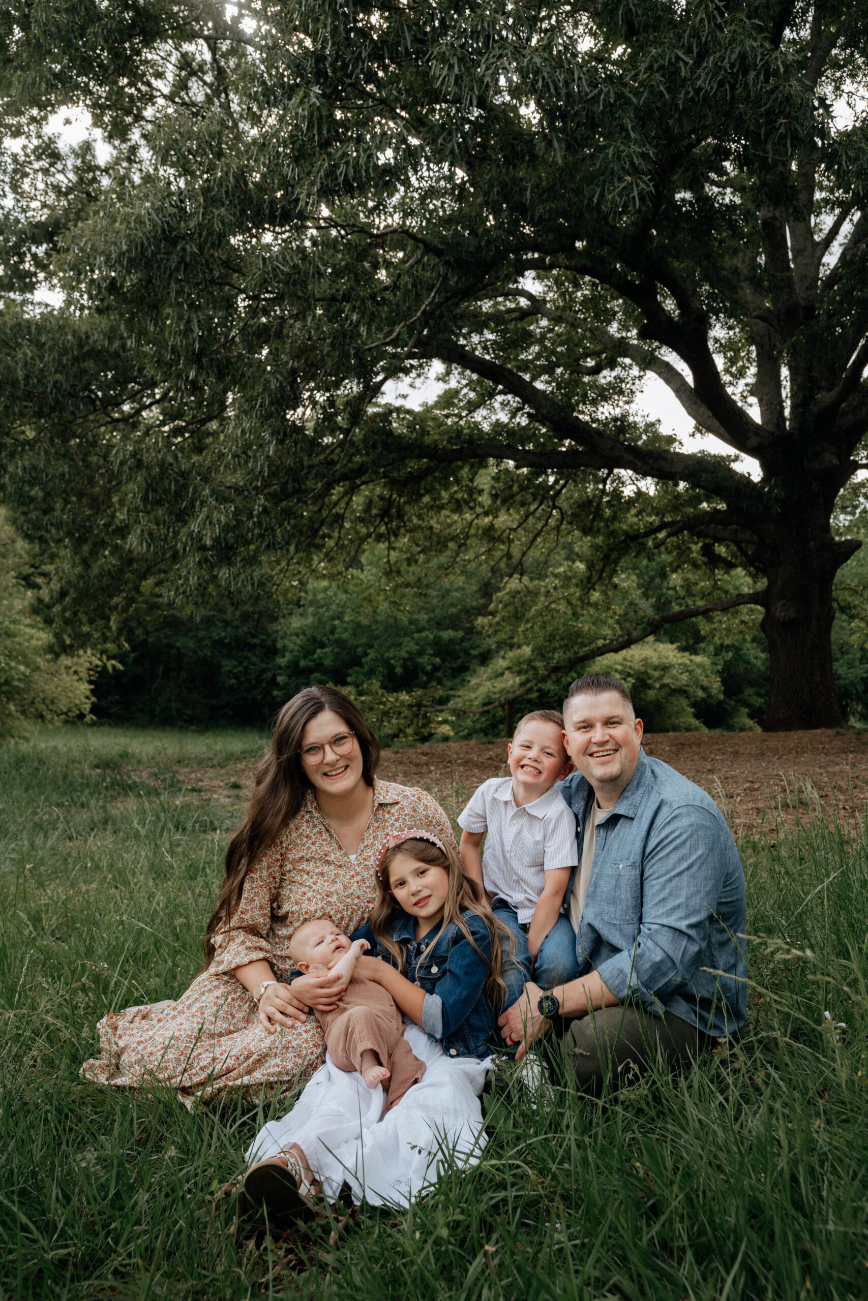 atlanta wedding photographer poses with her 3 children and husband