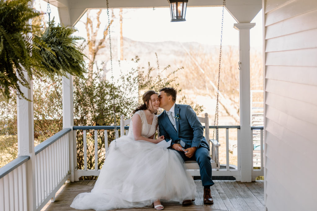 bride and groom sitting on front porch