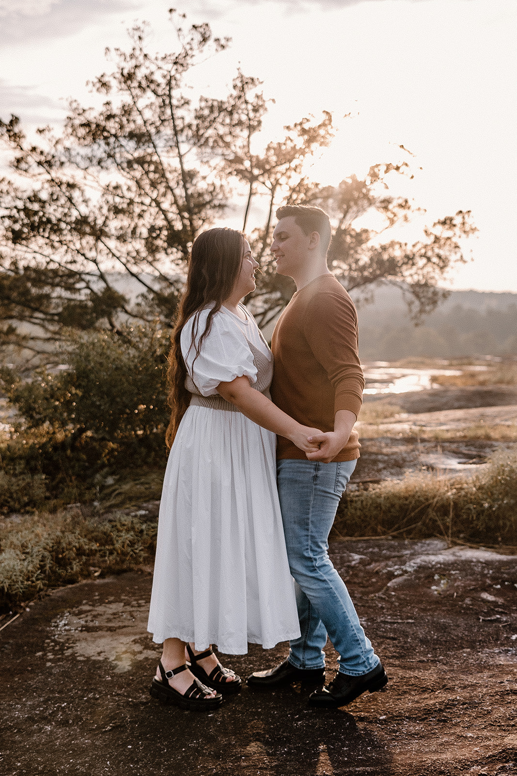 Golden Hour Sunset Engagement Photos dancing on top of Arabia Mountain. 