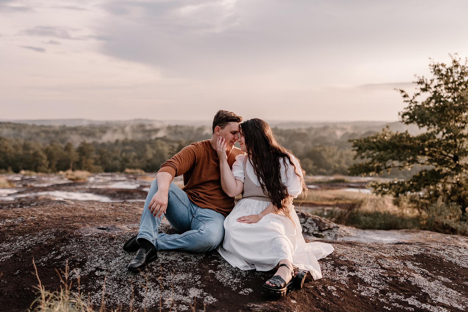 Golden Hour Sunset Engagement Photos sitting on top of Arabia Mountain looking into each others eyes. 