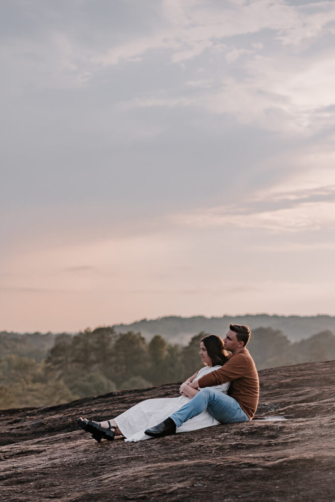 Adventure Couples Photo session sitting on mountaintop in north georgia mountains. 