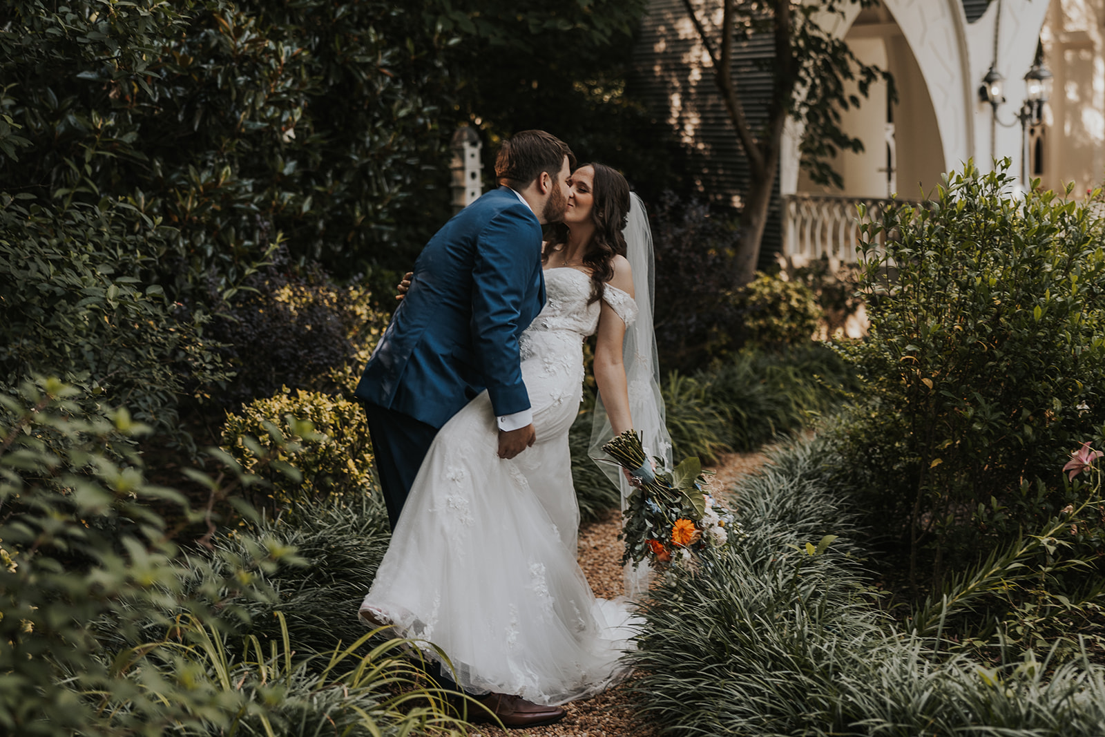 Stunning bride and groom pose for a photo outside Wildflower 301 in Georgia