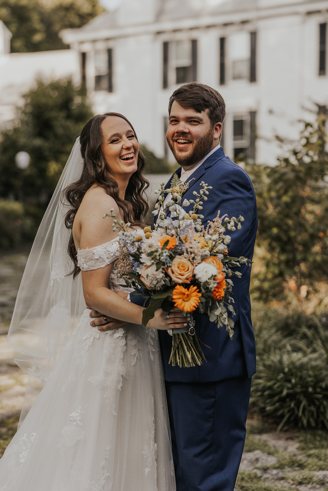 Stunning bride and groom pose for a photo outside Wildflower 301 in Georgia
