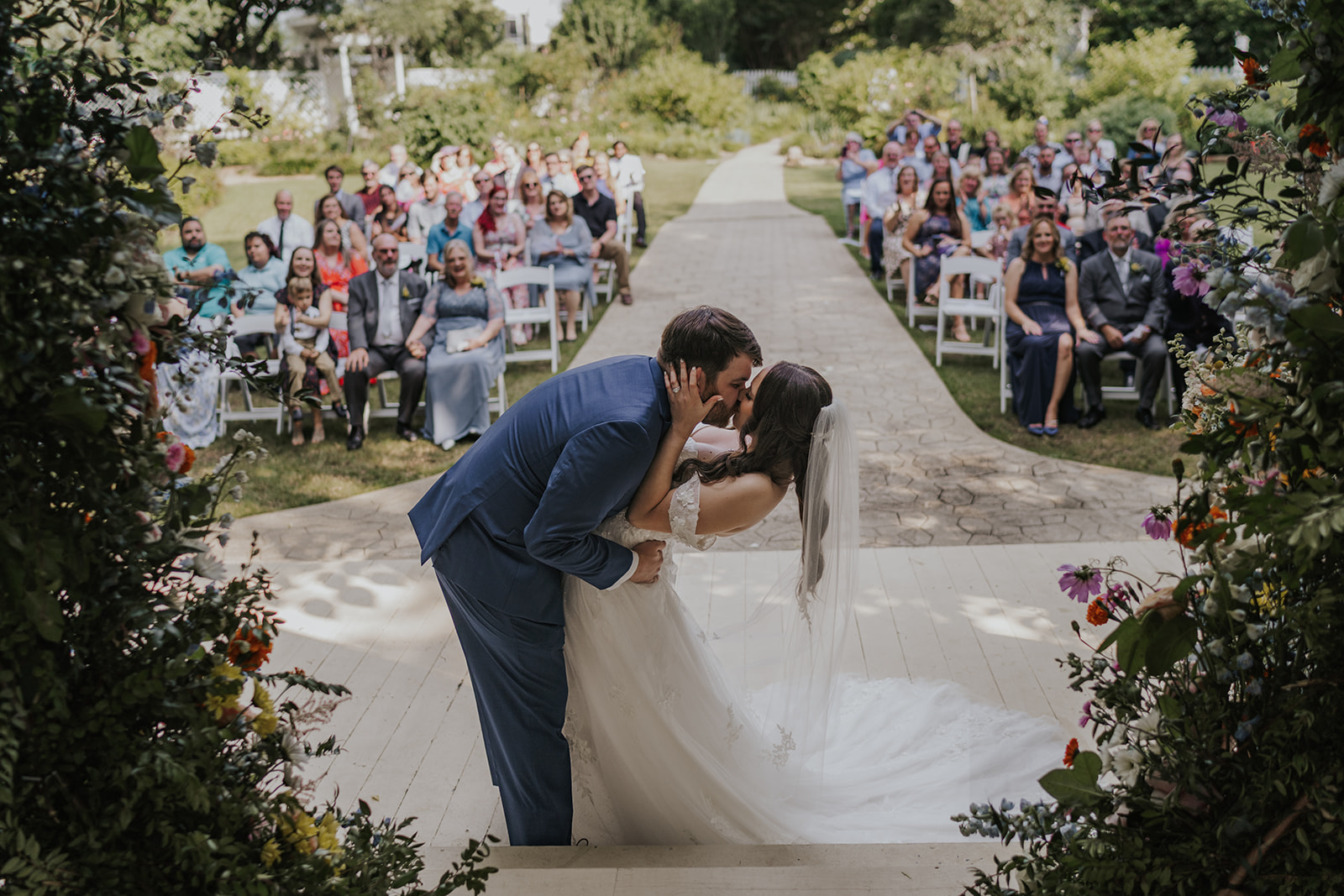 Stunning bride and groom pose share a kiss after their ceremony