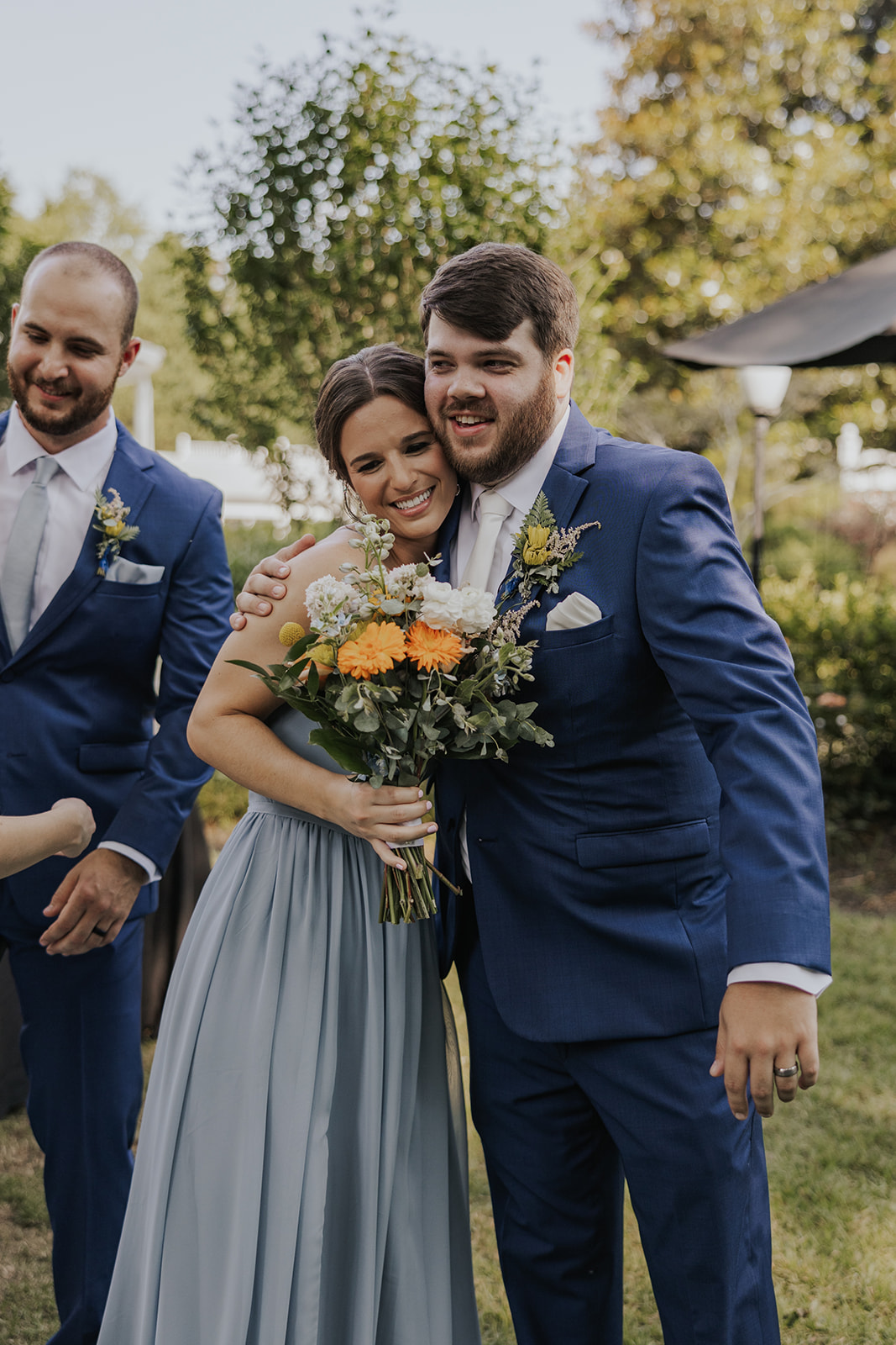 Groom shares a hug with a bridesmaid after his sentimental Georgia wedding