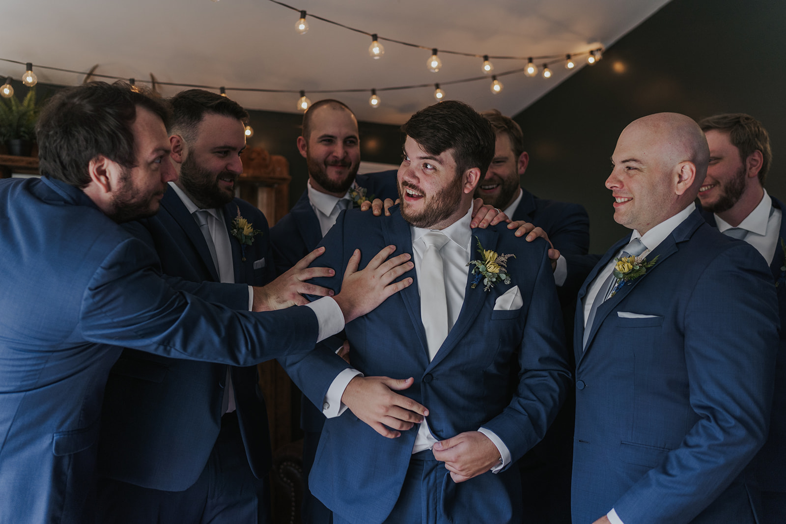 Groomsmen help groom get ready for his sentimental Georgia wedding