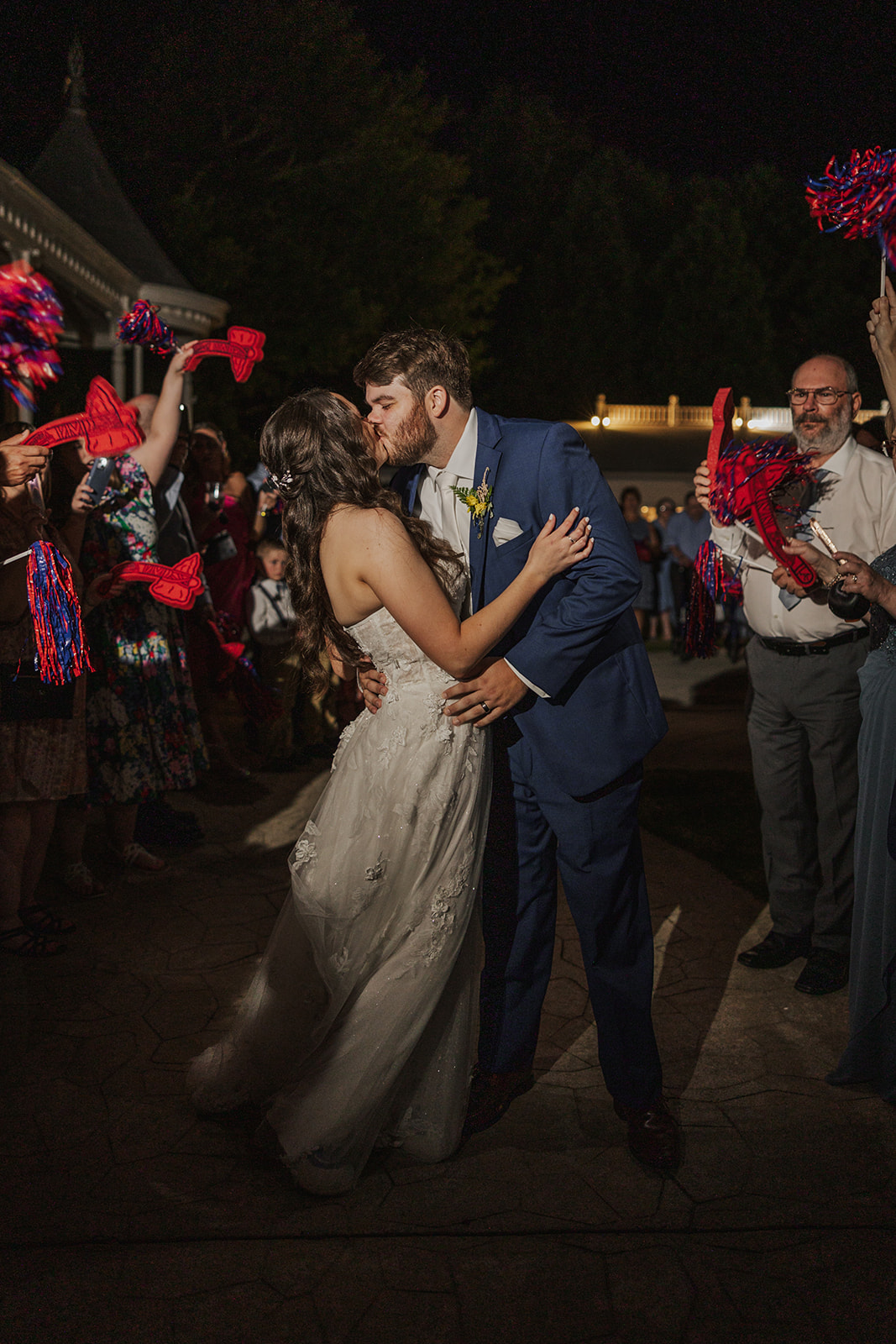 Stunning bride and groom share a kiss during their exit from their sentimental Georgia wedding