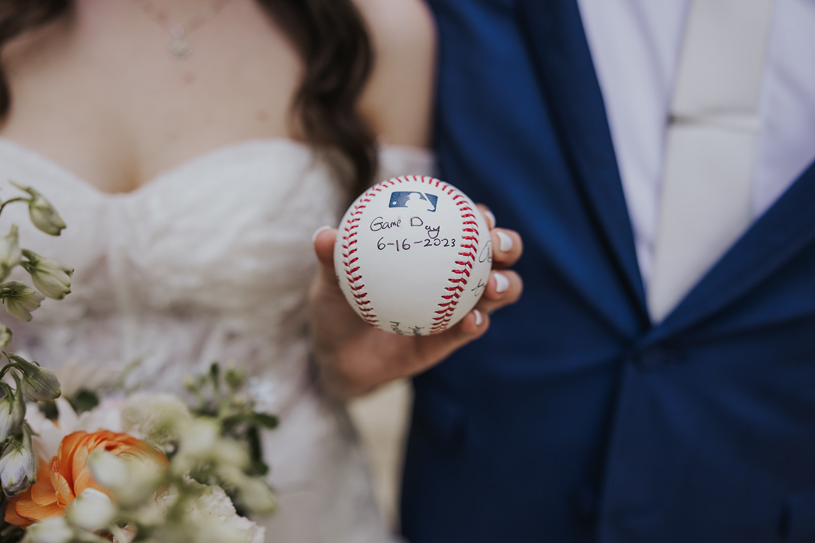 A baseball that has notes from the bride and groom written on it