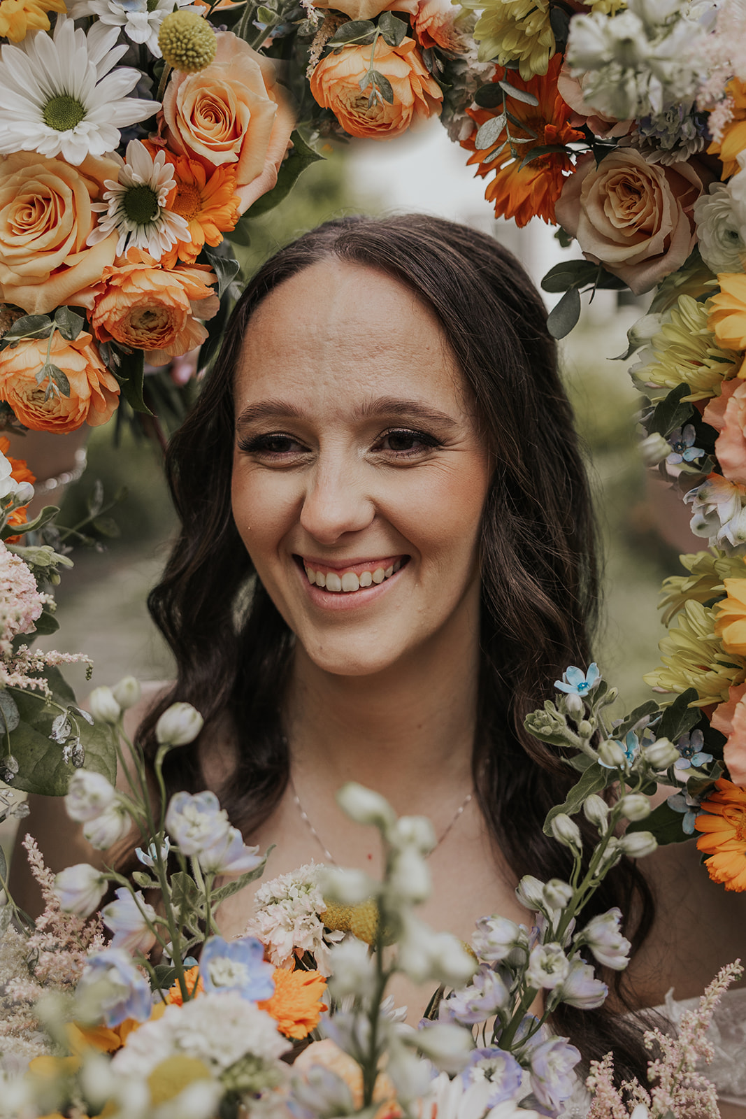 Stunning bride takes a photo looking through her flowers after her Sentimental Georgia wedding
