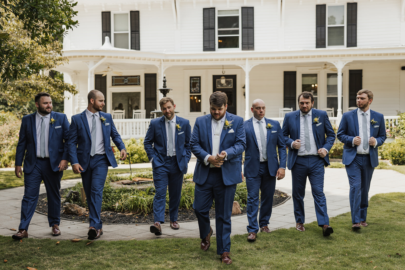 Groomsmen pose for a picture together outside Wildflower 301