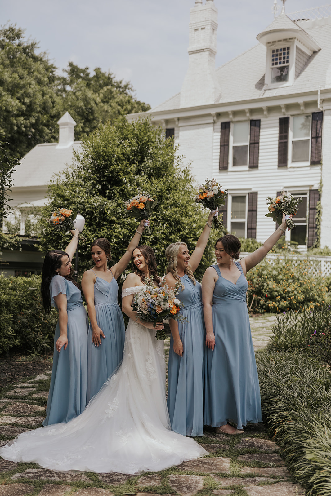 Bridesmaids take a photo with the stunning bride after her sentimental Georgia wedding