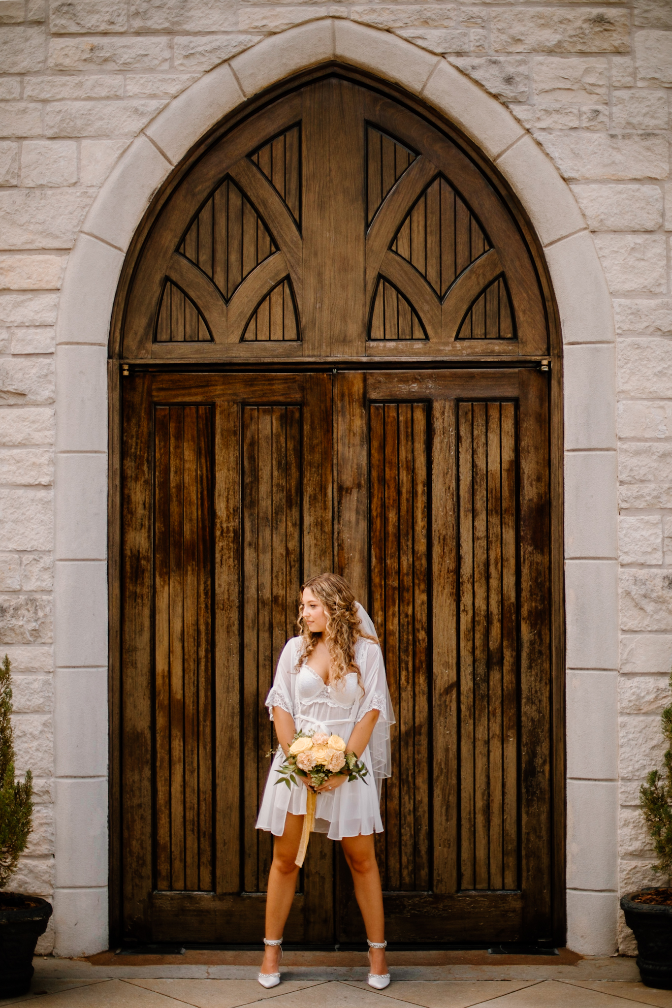 Stunning bride poses outside the door to her Georgia wedding venue