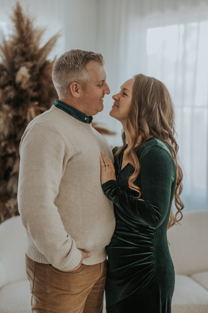 Couple share a moment together during a family Christmas photoshoot