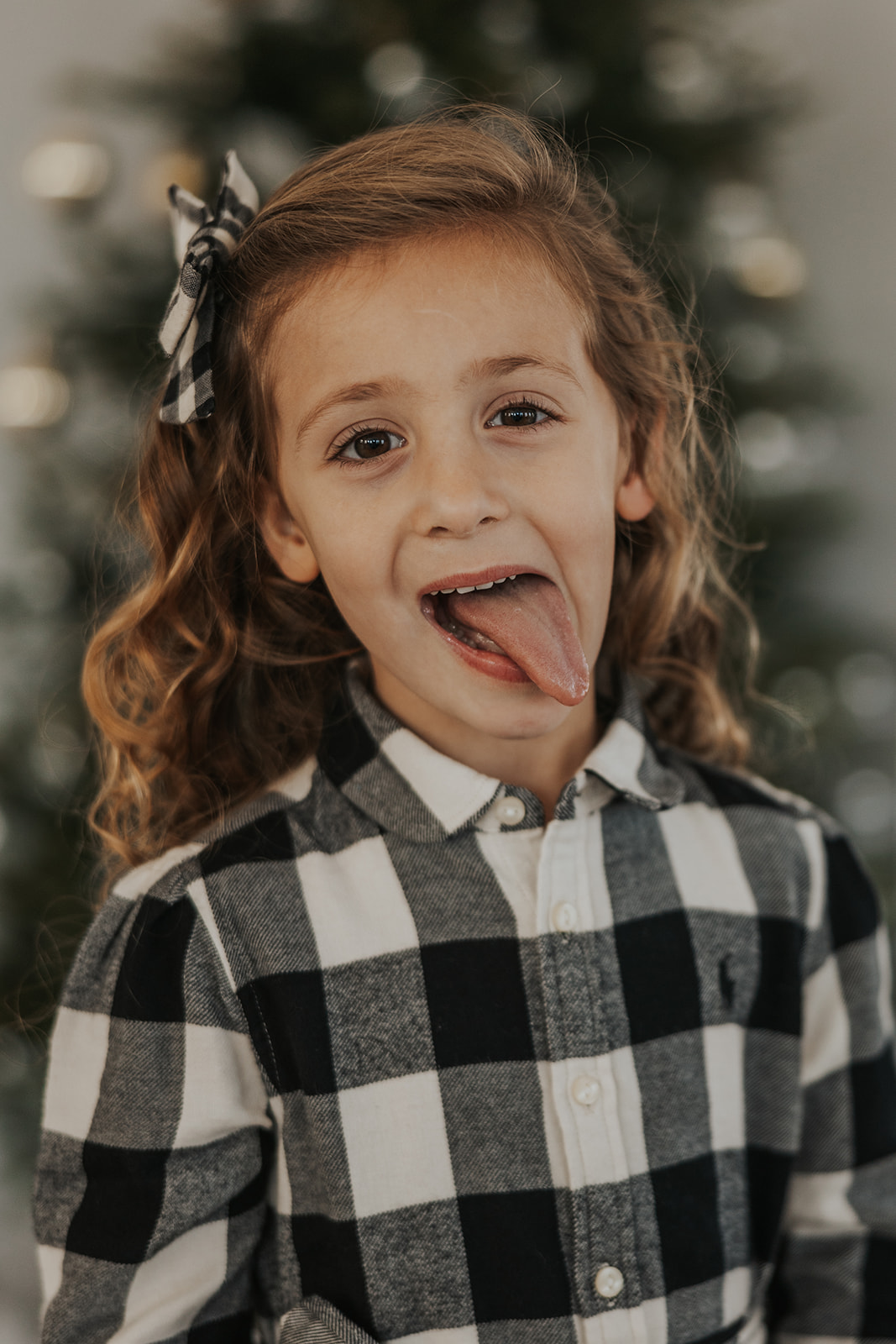 Young girl makes a silly face during a Christmas photoshoot