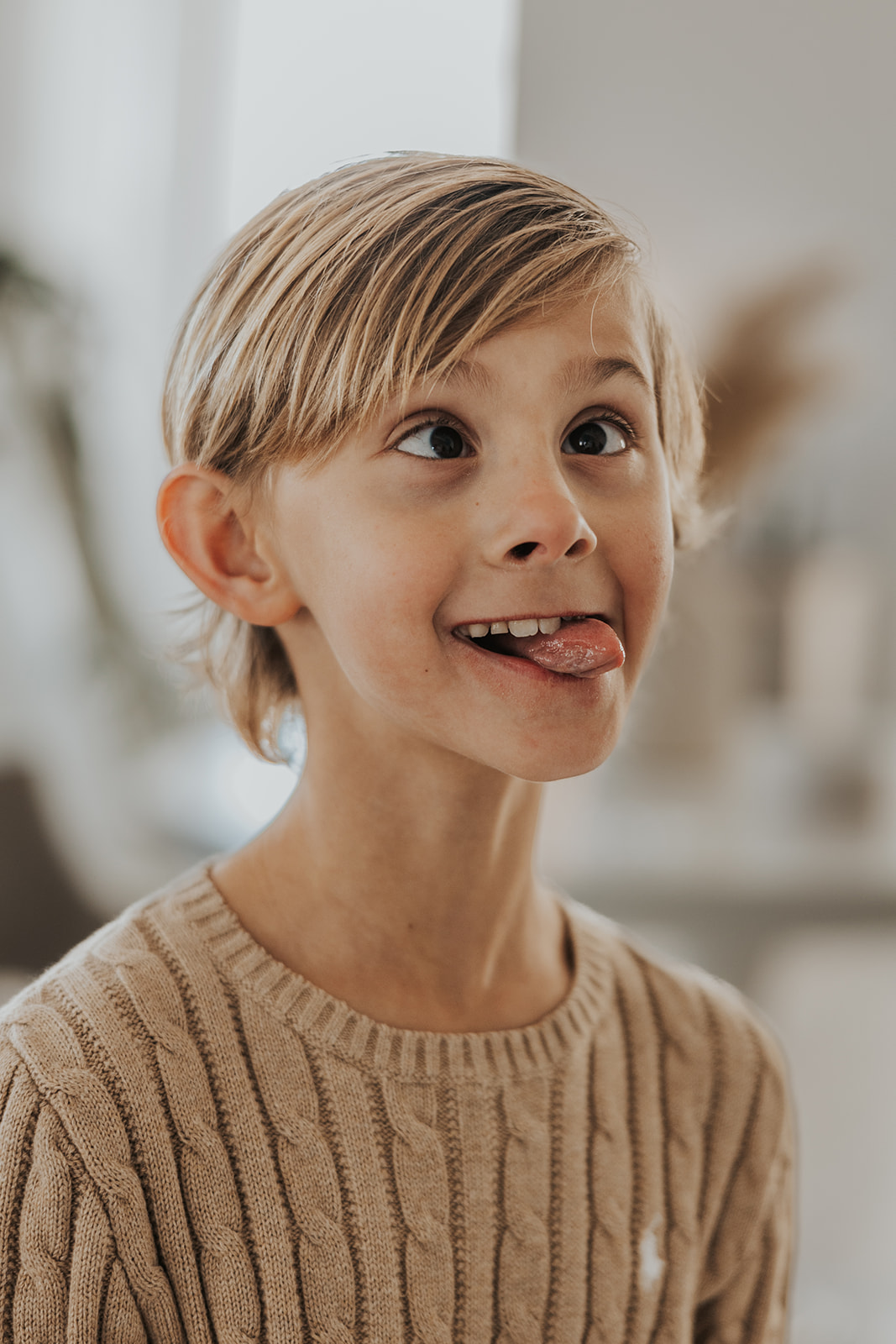 Young boy makes a silly face during a Christmas photoshoot
