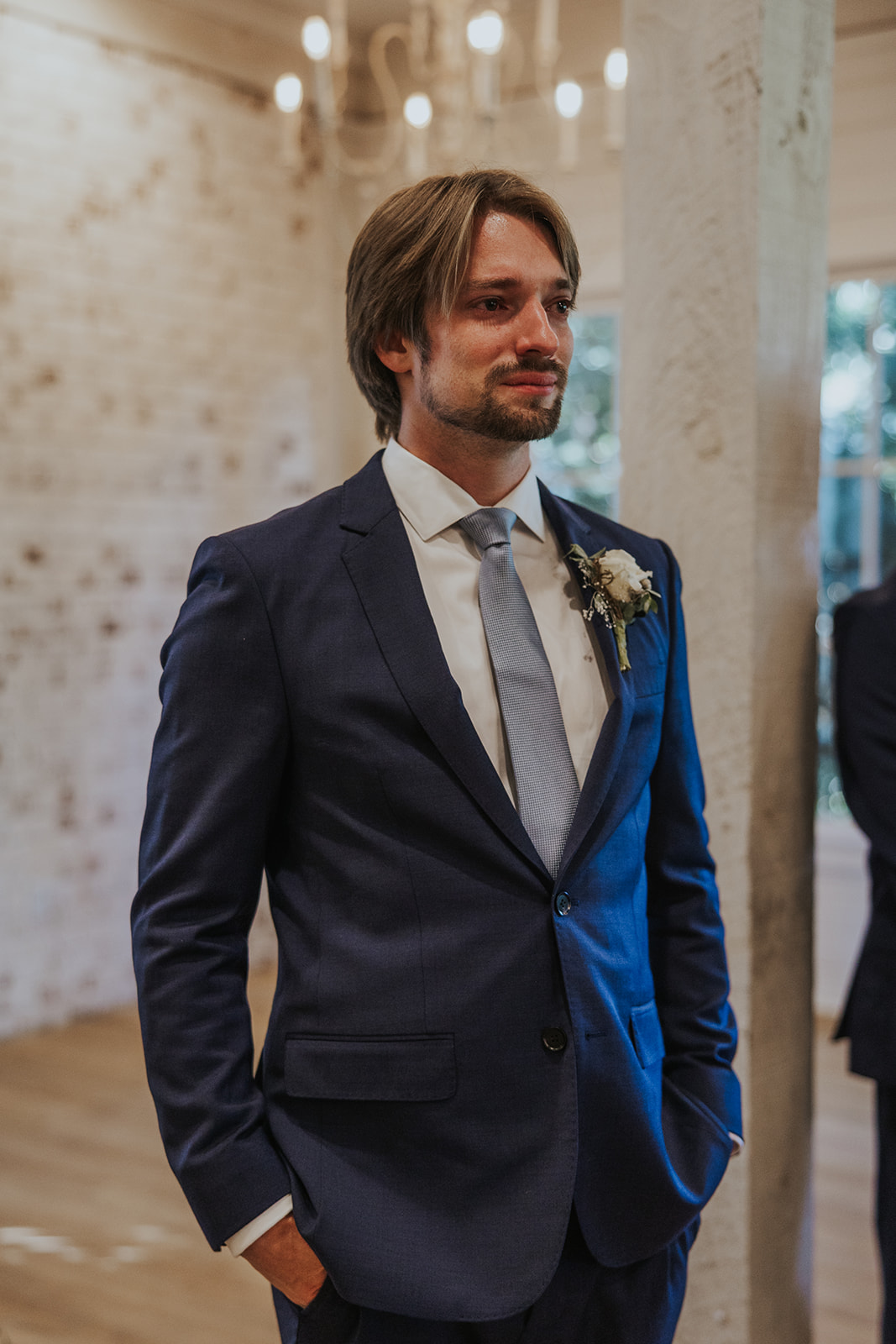 Handsome groom waits on his stunning bride to come down the aisle on their dreamy Georgia wedding day