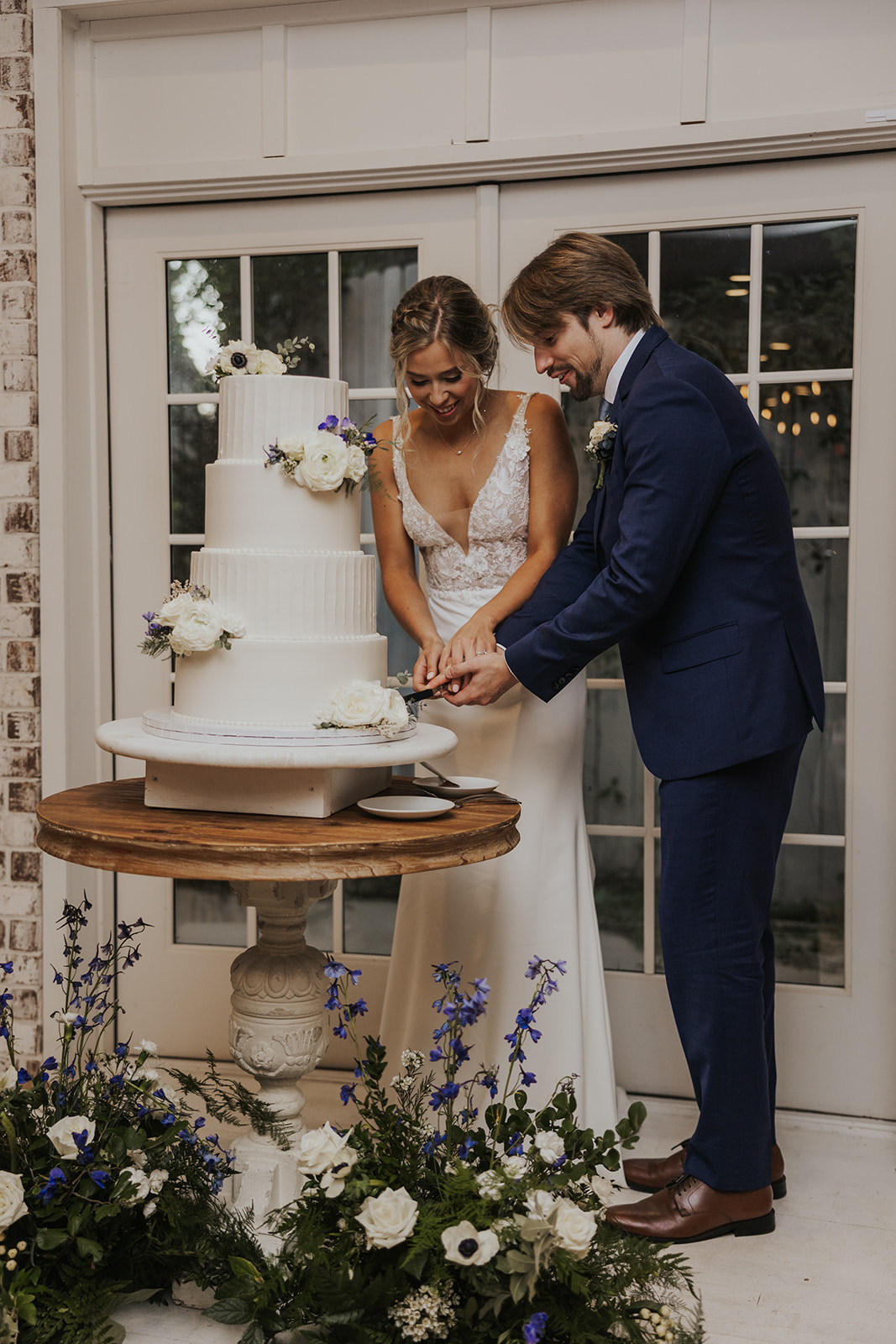 Beautiful bride and groom cut their cake at their dreamy Georgia wedding reception