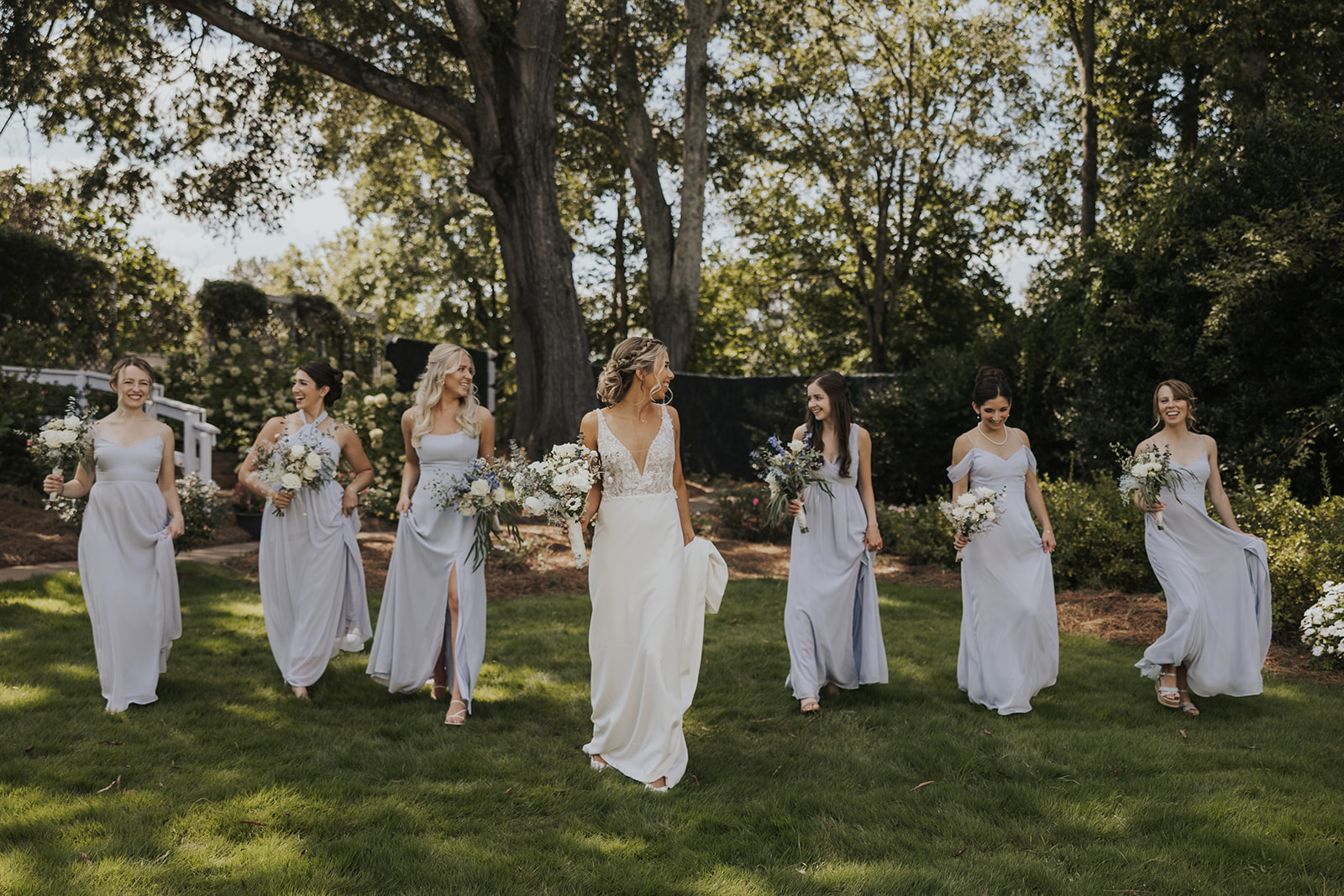 Stunning bride poses with her bridesmaids before her Georgia barn wedding at wildflower barn at little river farms