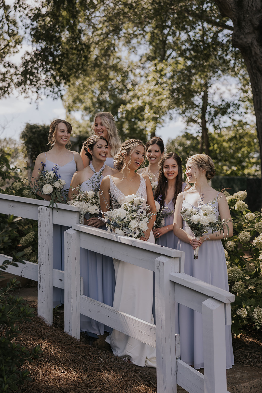 Stunning bride poses with her bridesmaids before her Georgia barn wedding at wildflower barn at little river farms