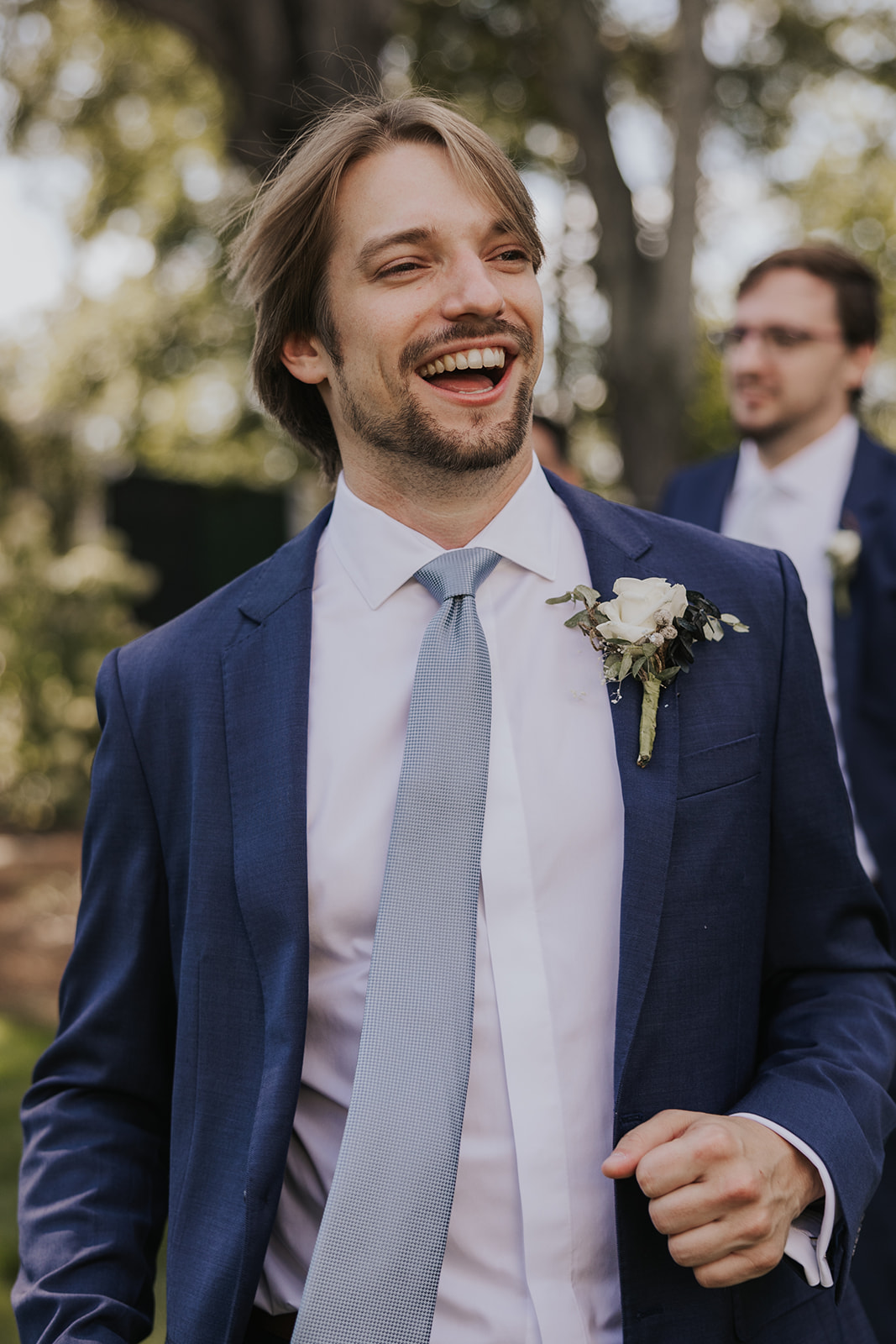 Handsome groom poses candidly on his dreamy Georgia wedding day at wildflower barn at little river farms
