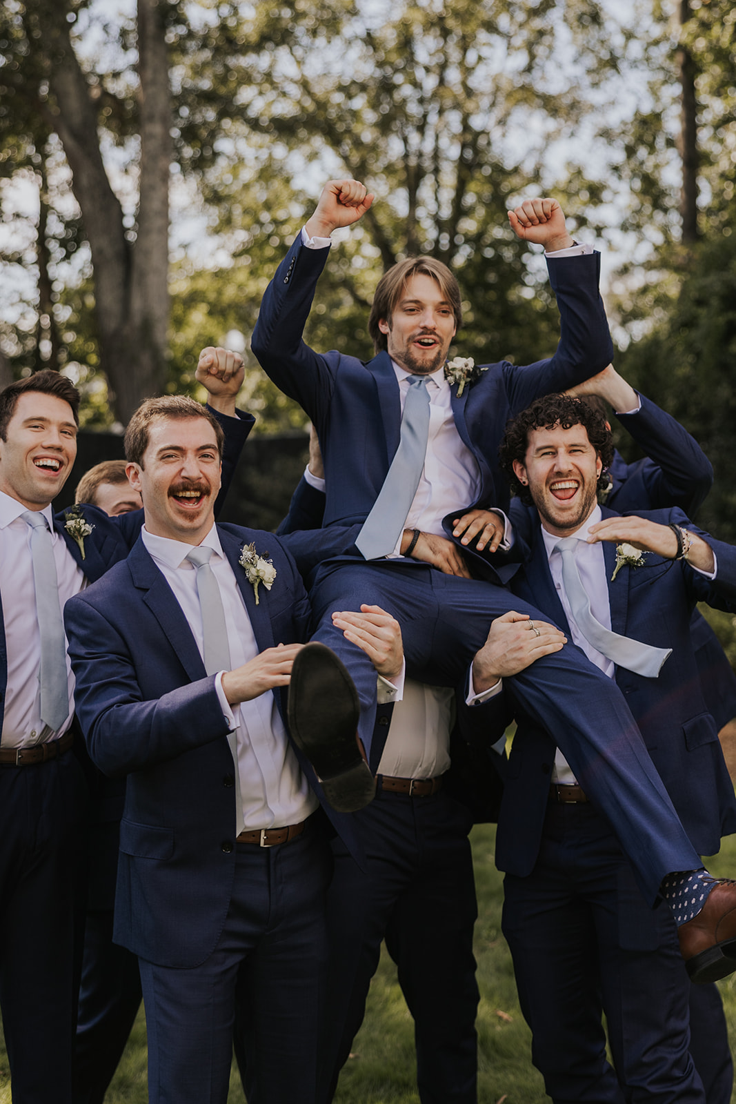 Groom and groomsmen celebrate the dreamy Georgia wedding at wildflower barn at little river farms