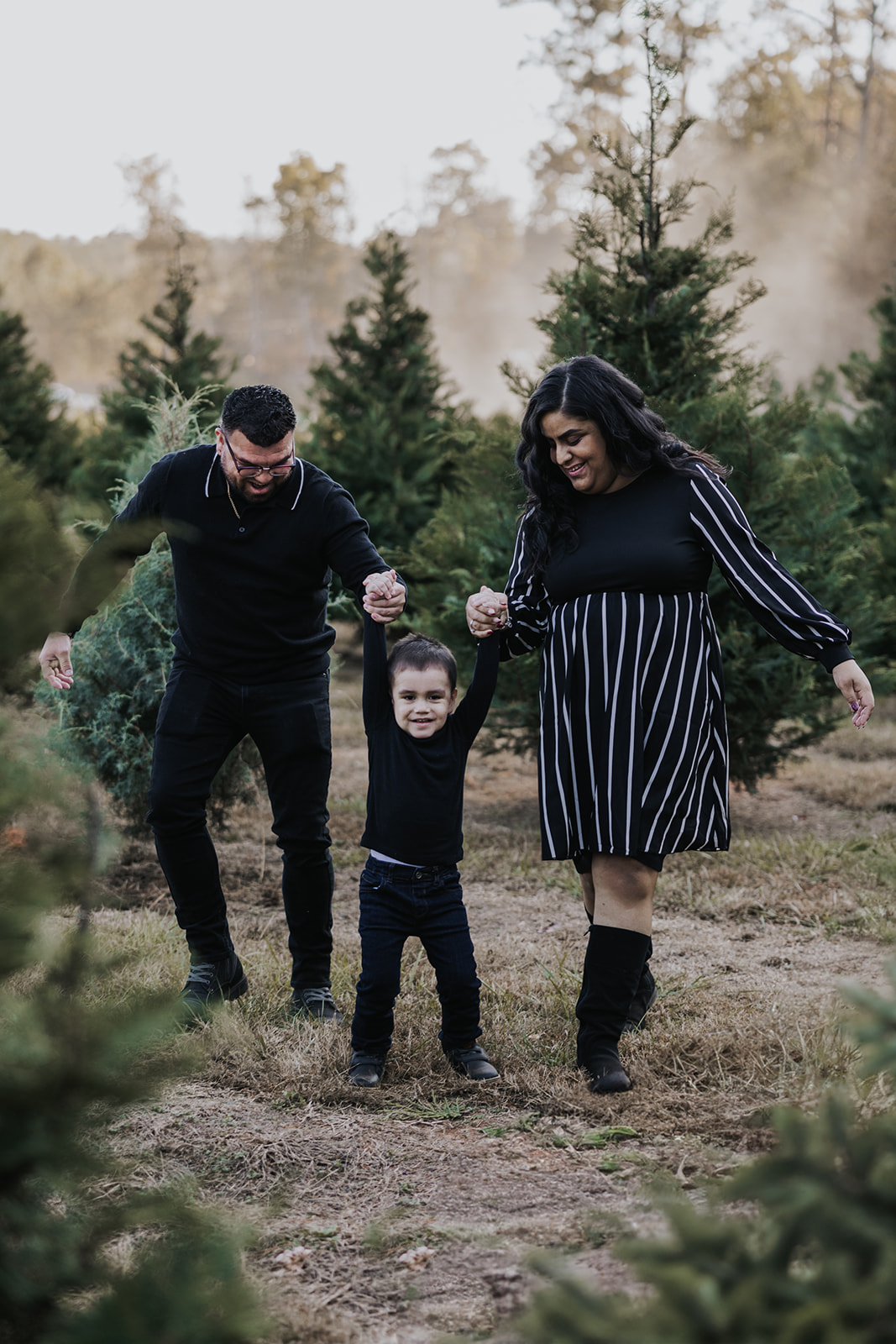 Stunning family pose together during their Christmas tree farm family photos