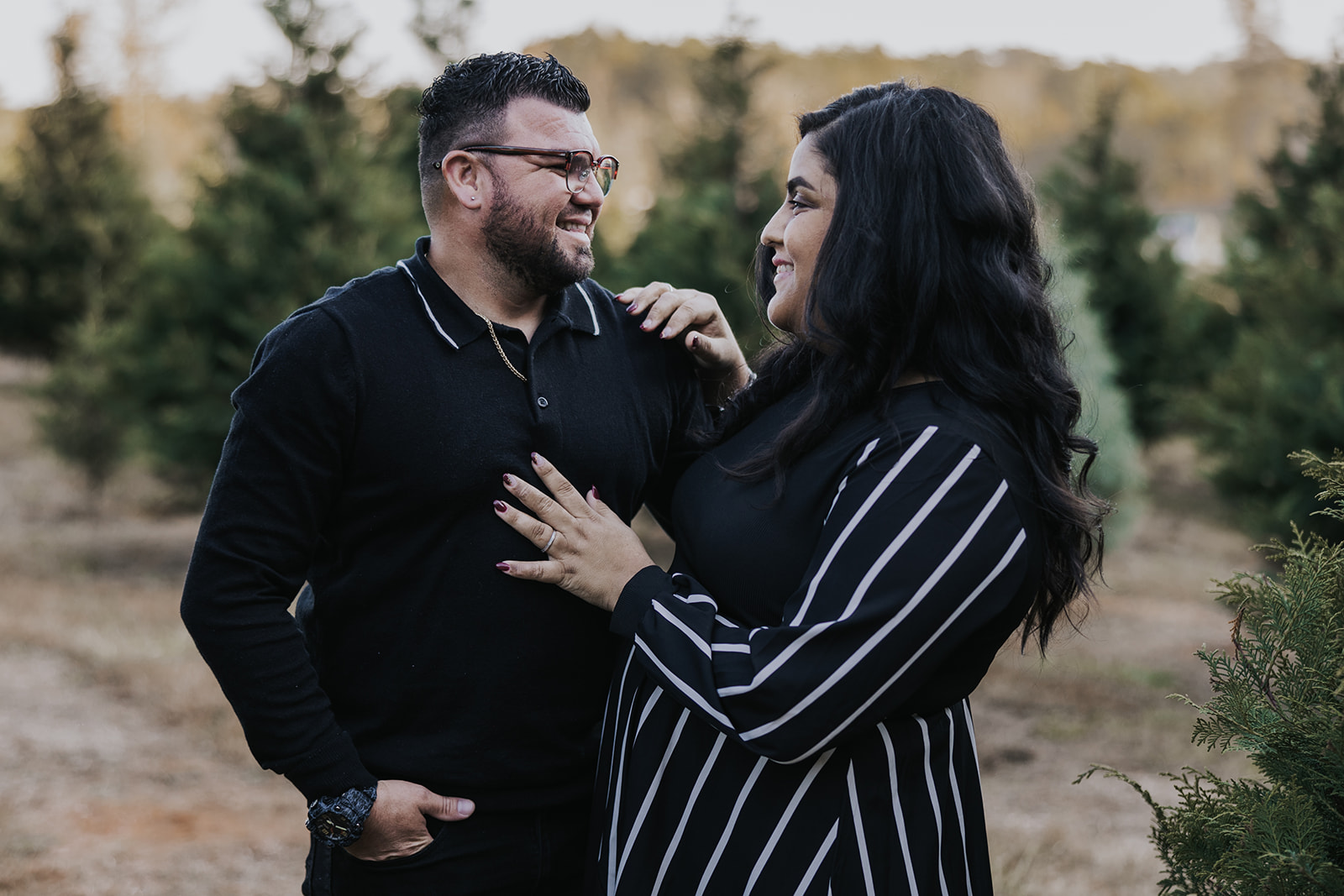 Stunning couple pose together during their Christmas tree farm family photos
