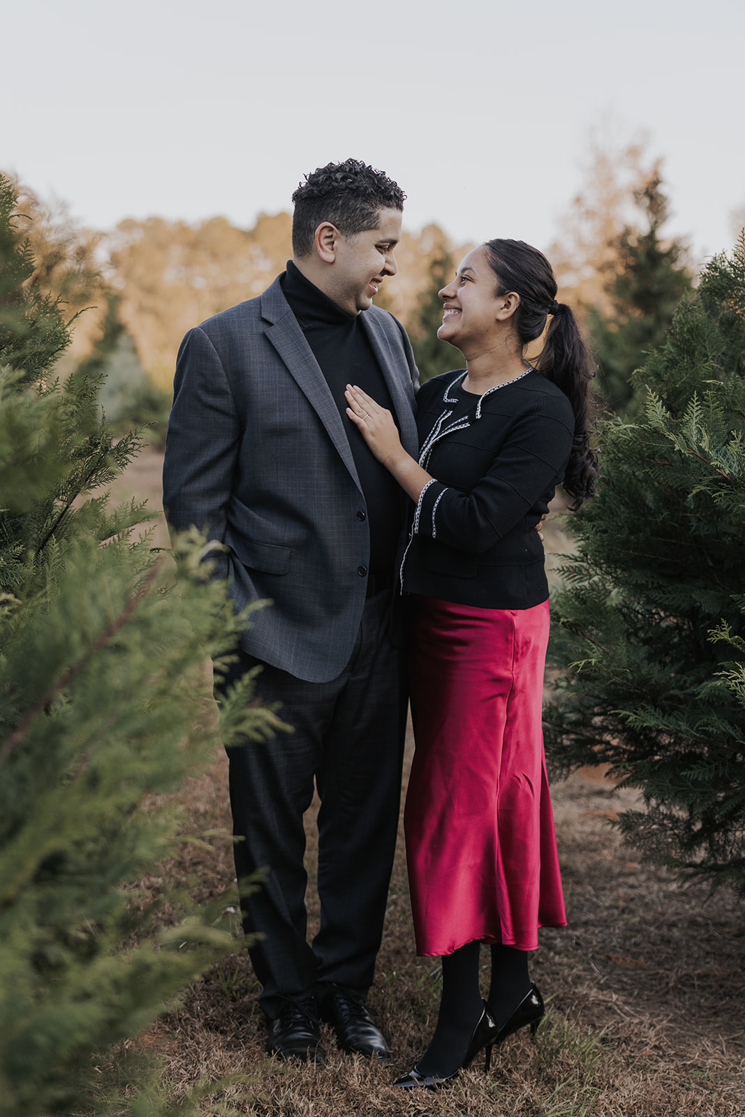 Stunning couple pose together during their Christmas tree farm family photos