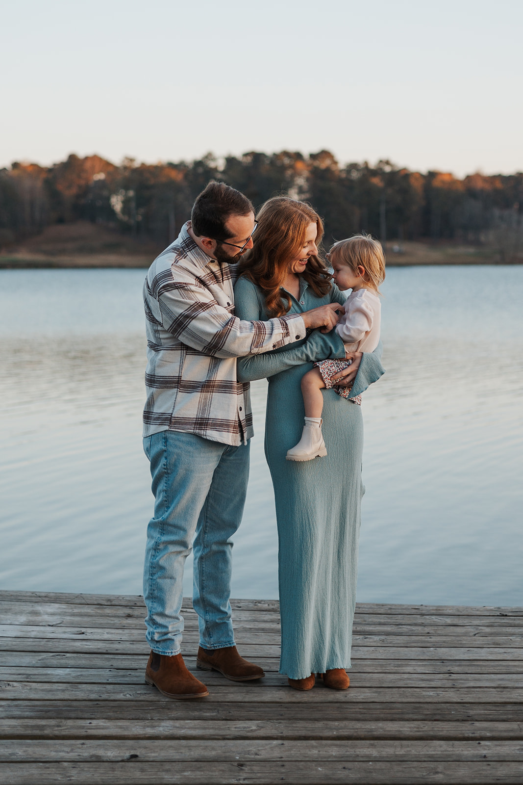 Stunning young family poses on a Georgia dock during their stress free family photos
