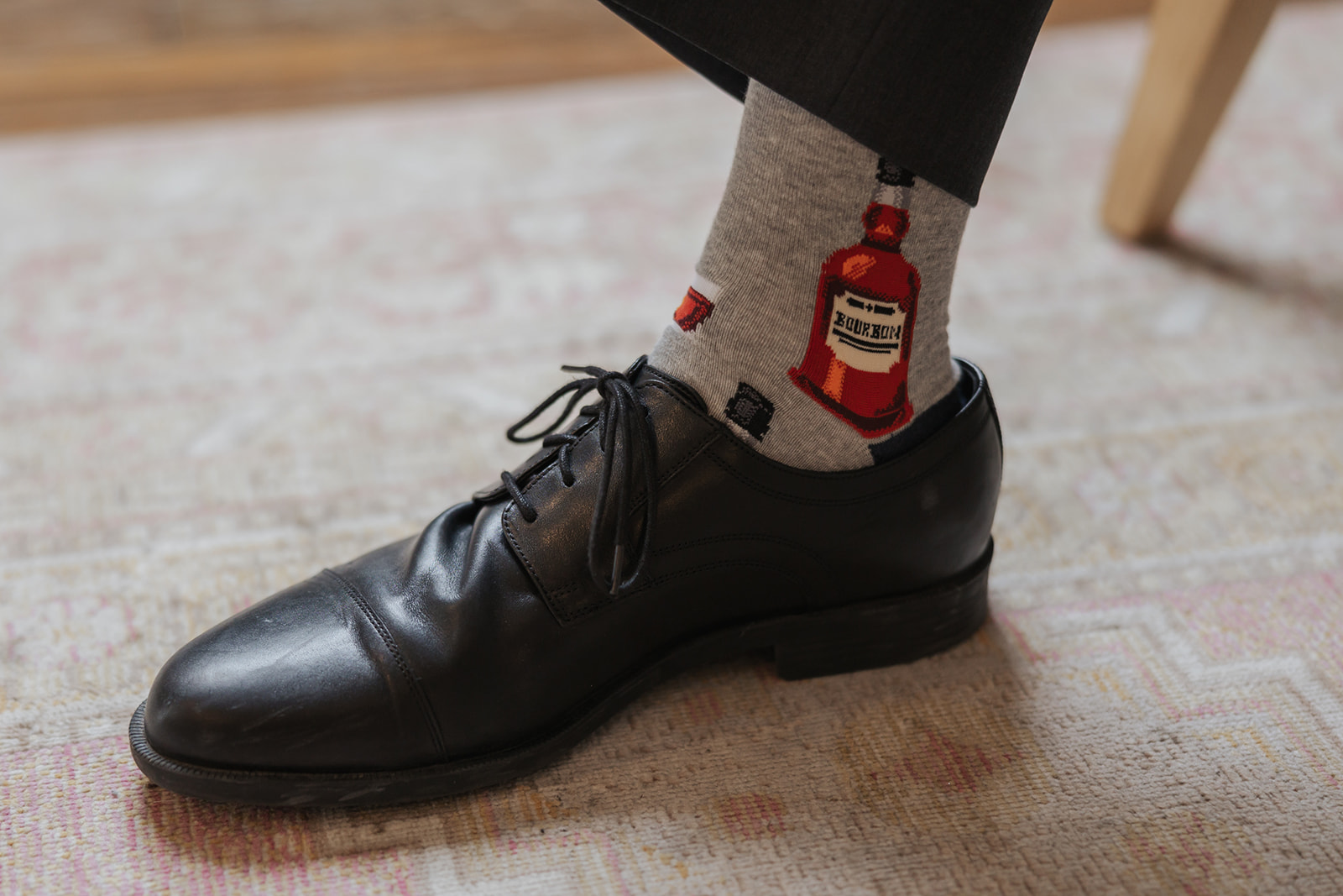 Groom shows off his hand picked socks for his wedding day
