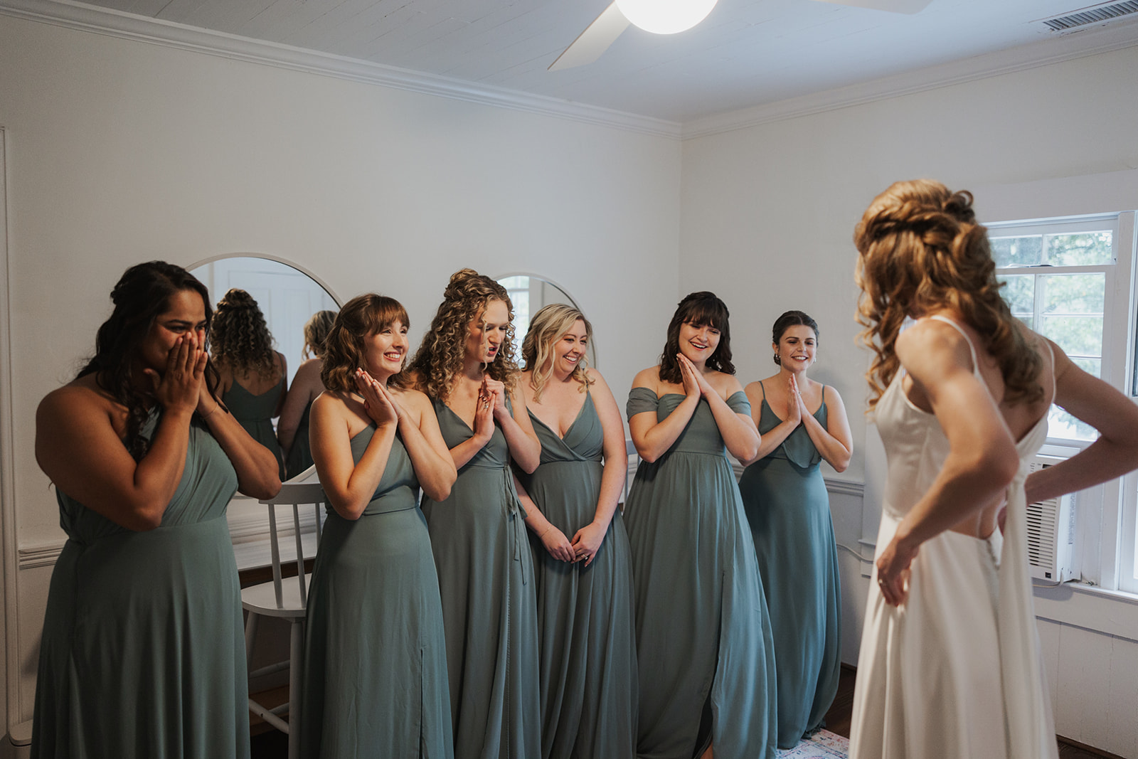 Bridesmaids pose together with the bride after her big wedding day