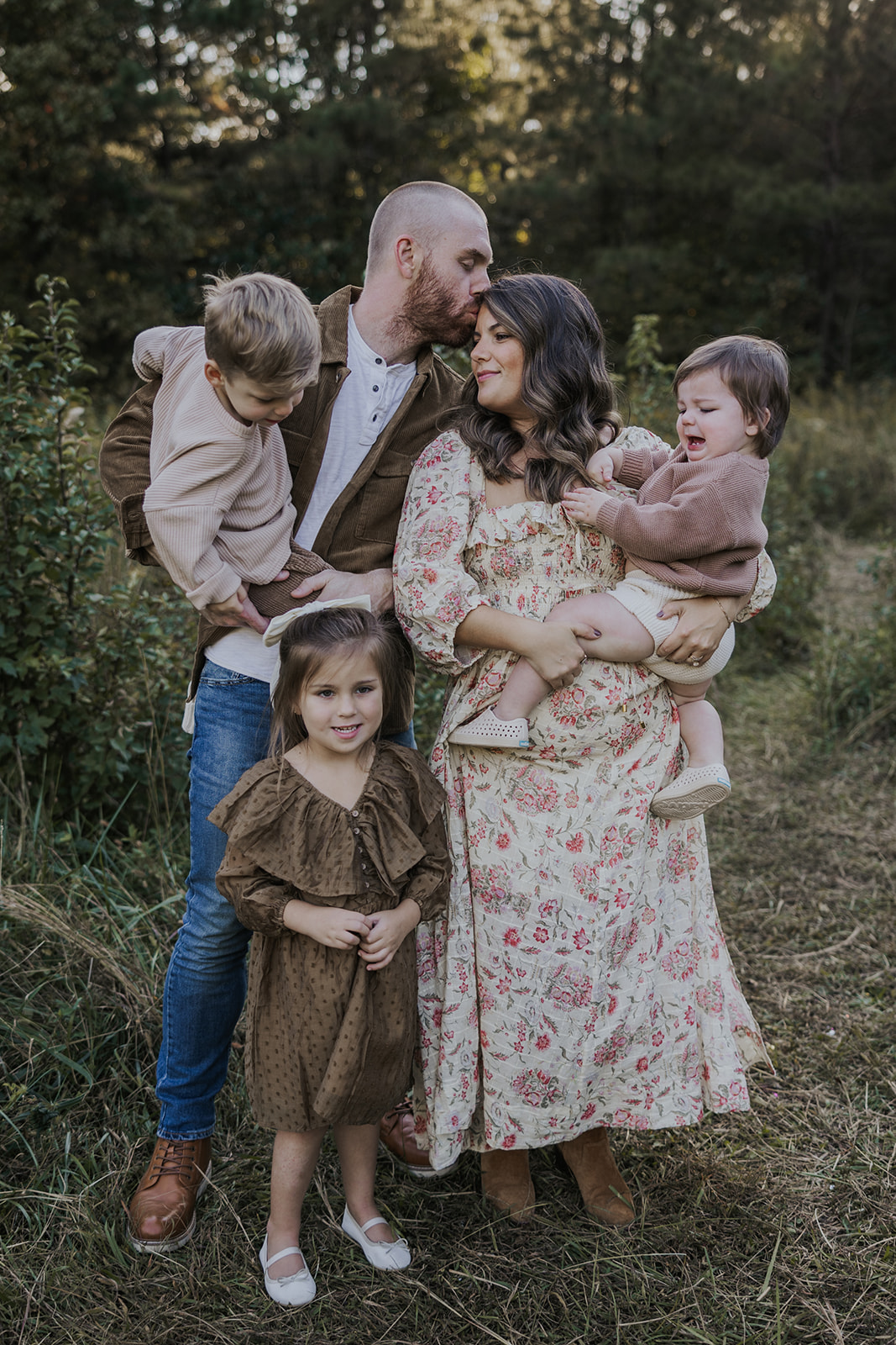 mom and dad pose together with their kids during her families Georgia photoshoot