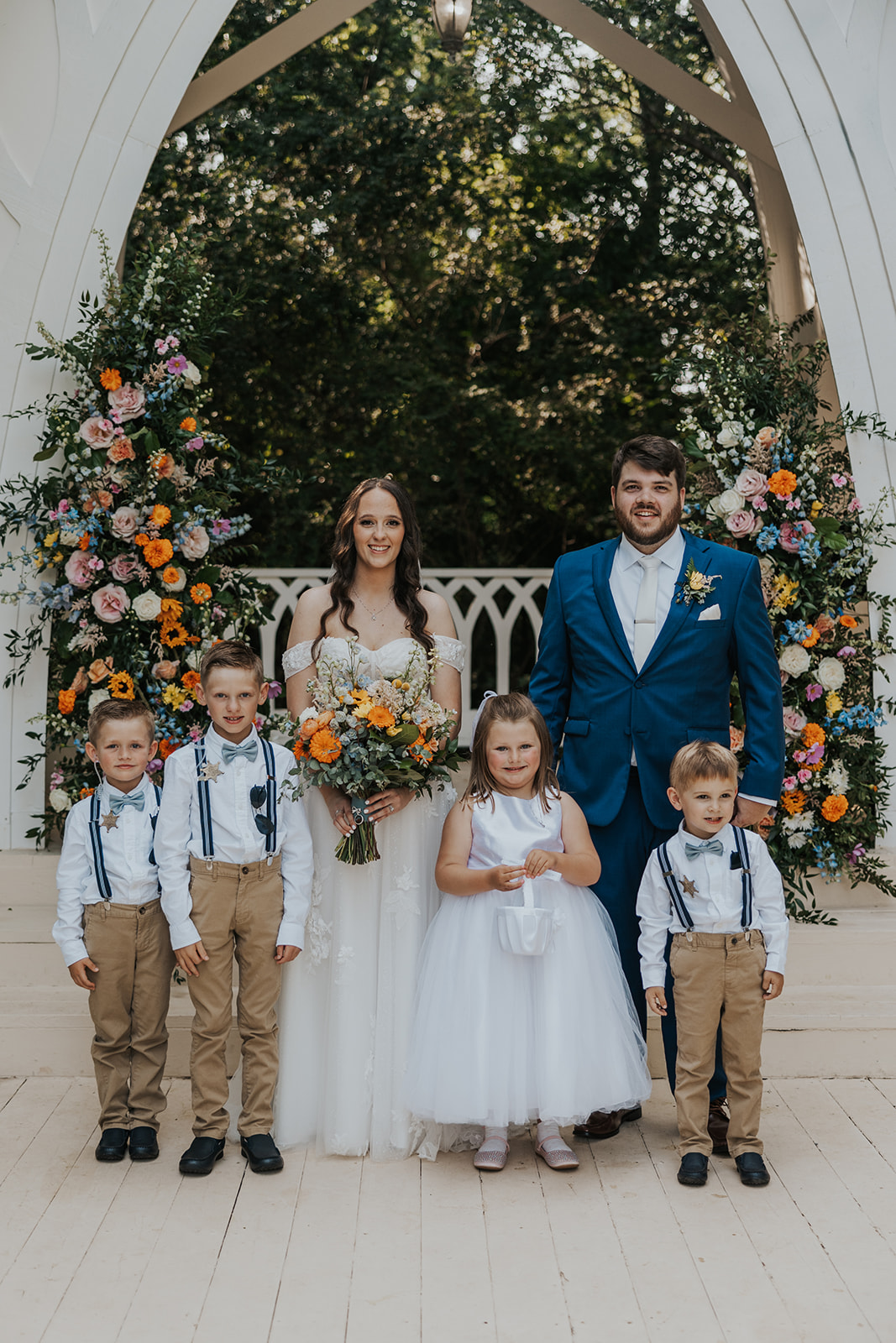 the bride and groom pose with kids