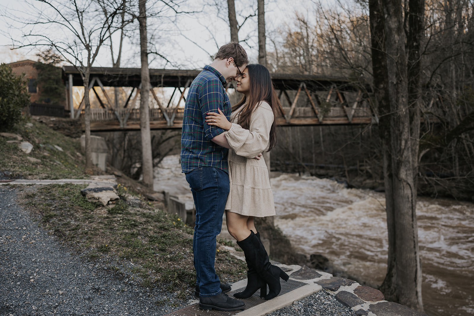 Stunning couple pose by the Roswell Mill covered bridge during their Roswell Mill engagement photoshoot in Georgia