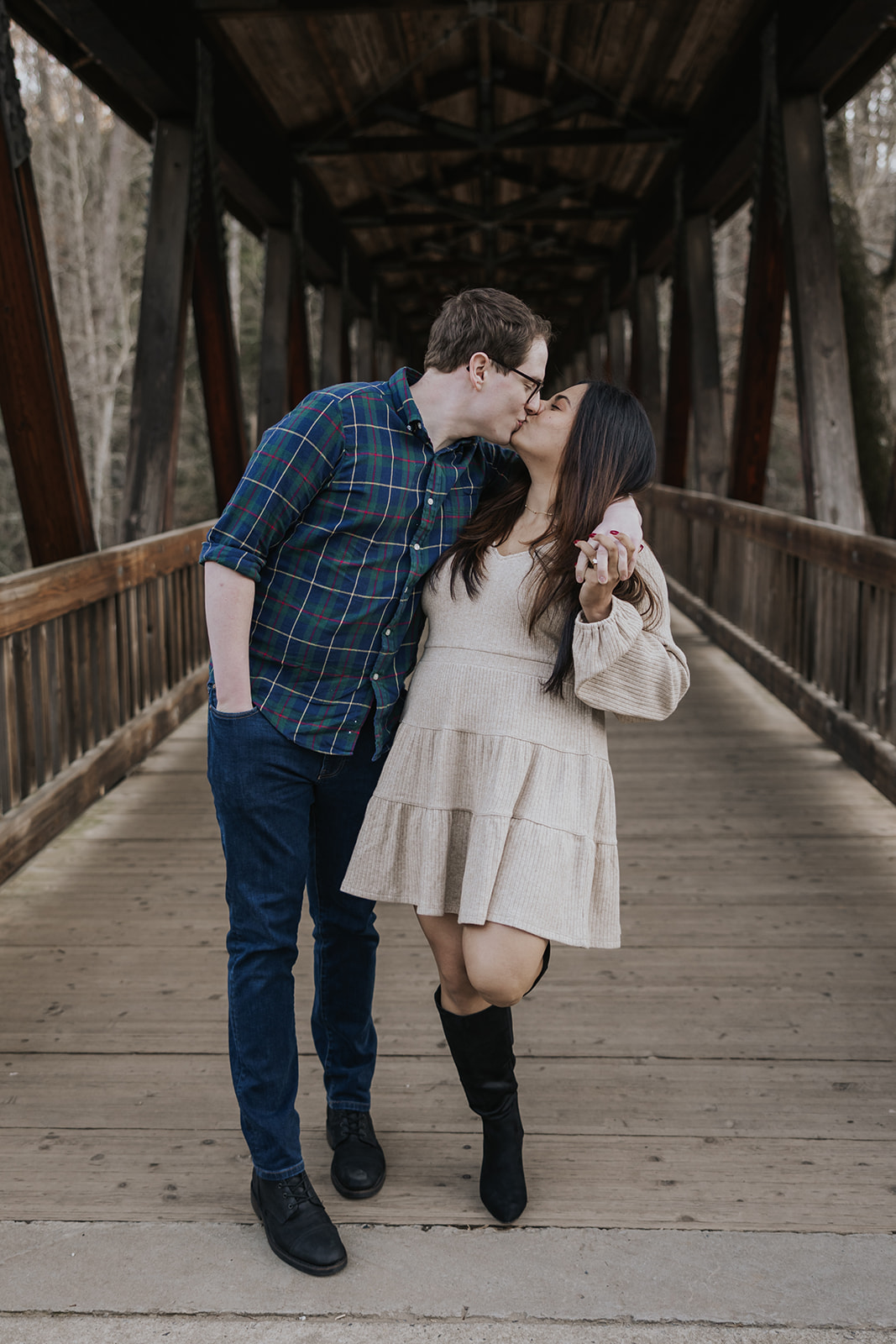 Stunning couple pose by the Roswell Mill covered bridge during their Roswell Mill engagement photoshoot in Georgia