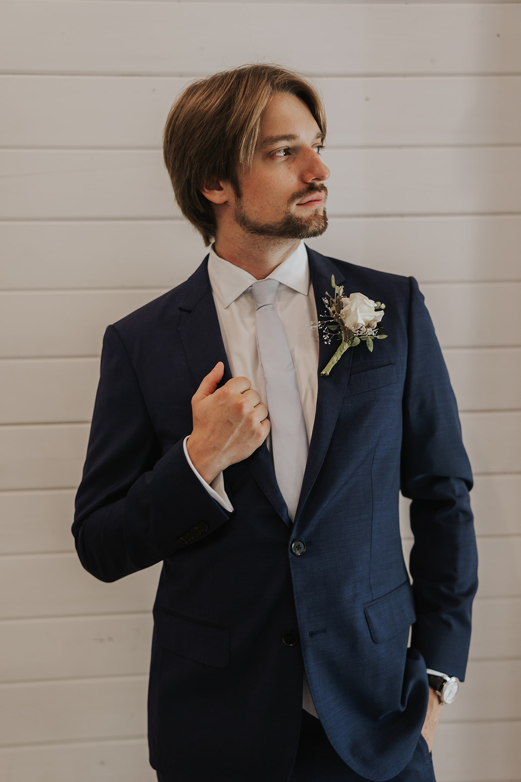 groom poses before his stunning wedding day