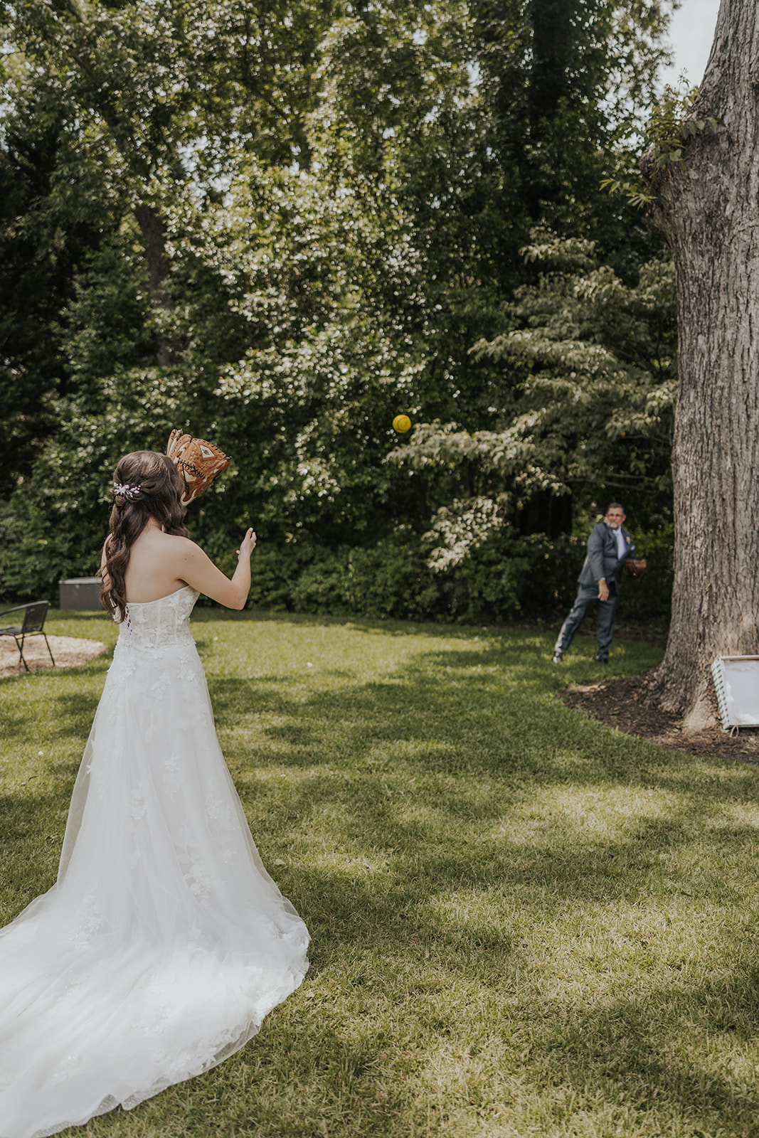 bride plays catch with her dad on her wedding day. Plan your perfect wedding day timeline!