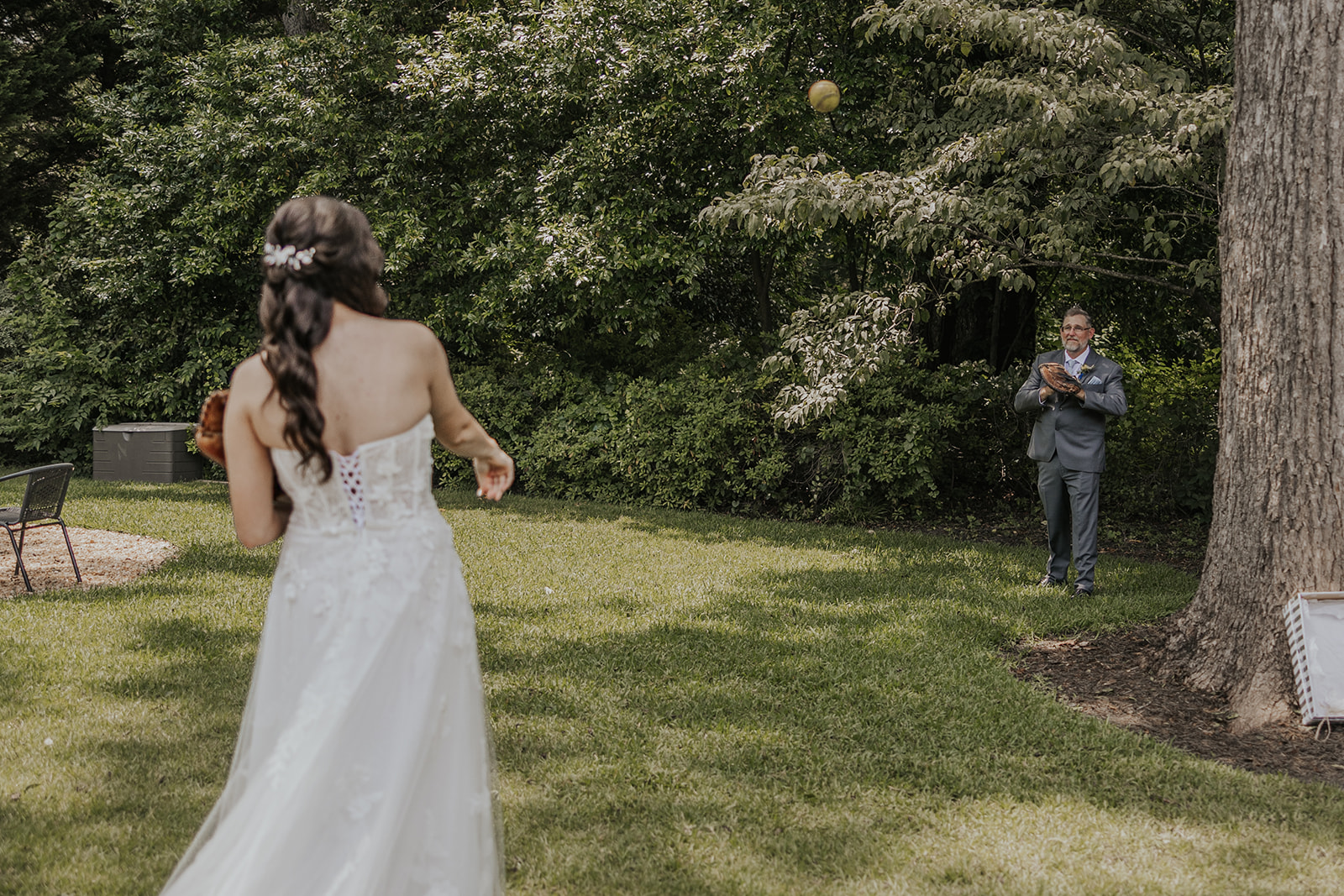 bride plays catch with her dad on her wedding day. Plan your perfect wedding day timeline!
