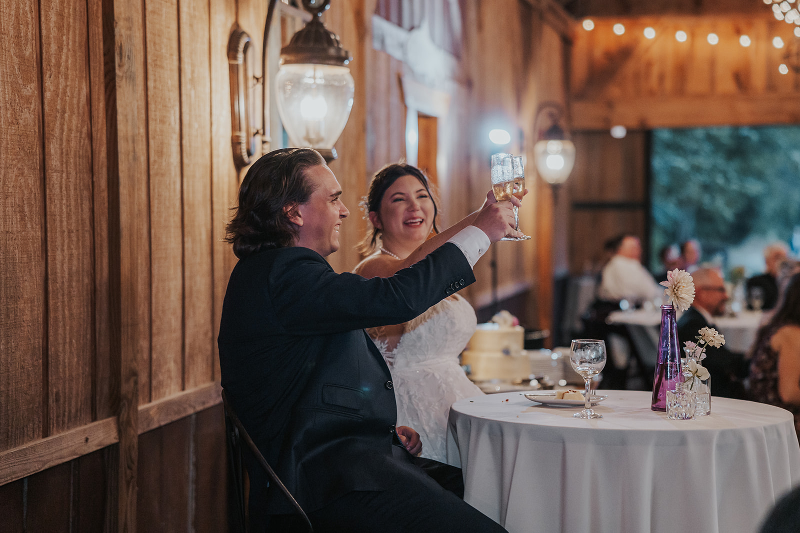 gorgeous bride and groom share a toast with their wedding guests 