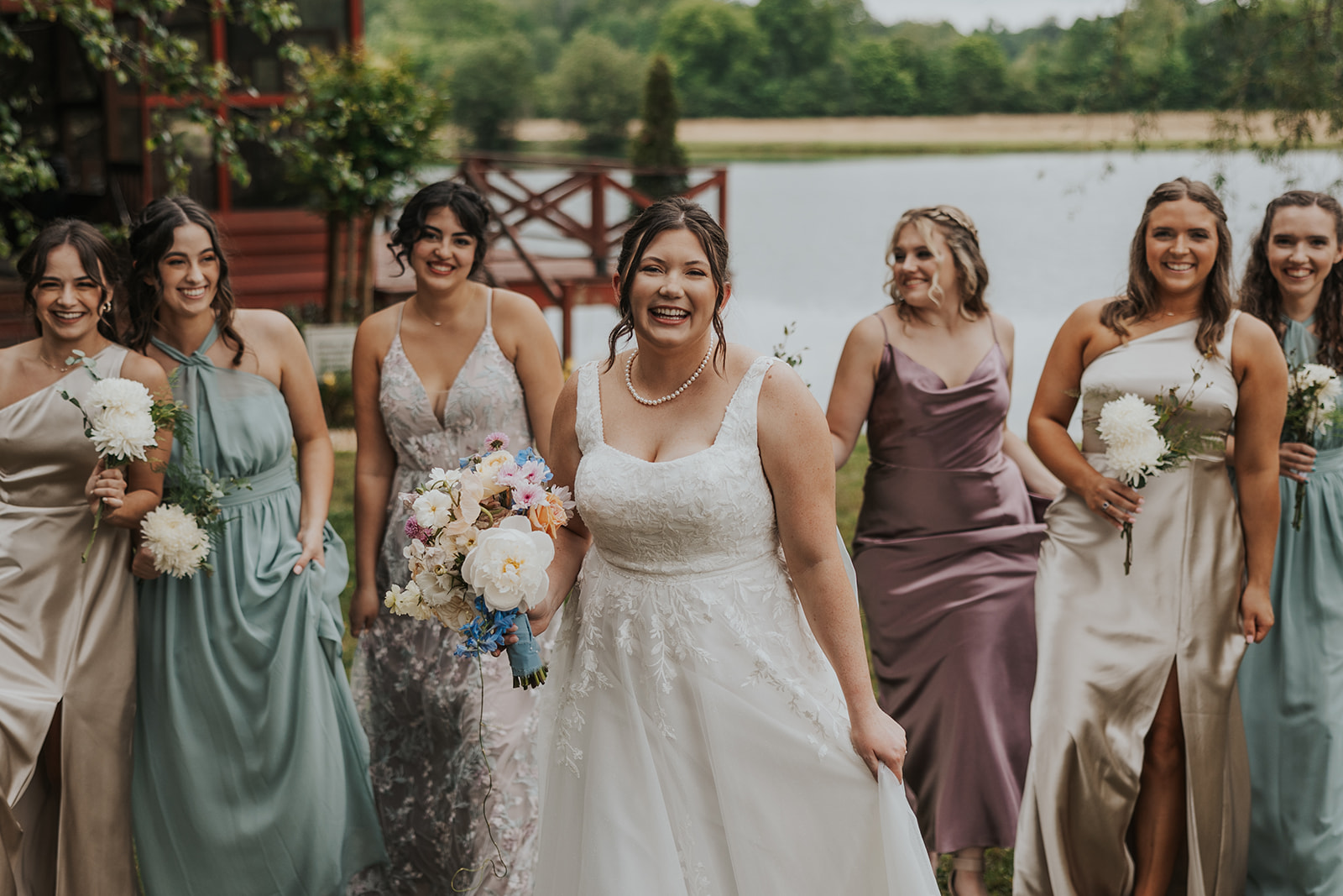 bride poses with her beautiful bridesmaids 
