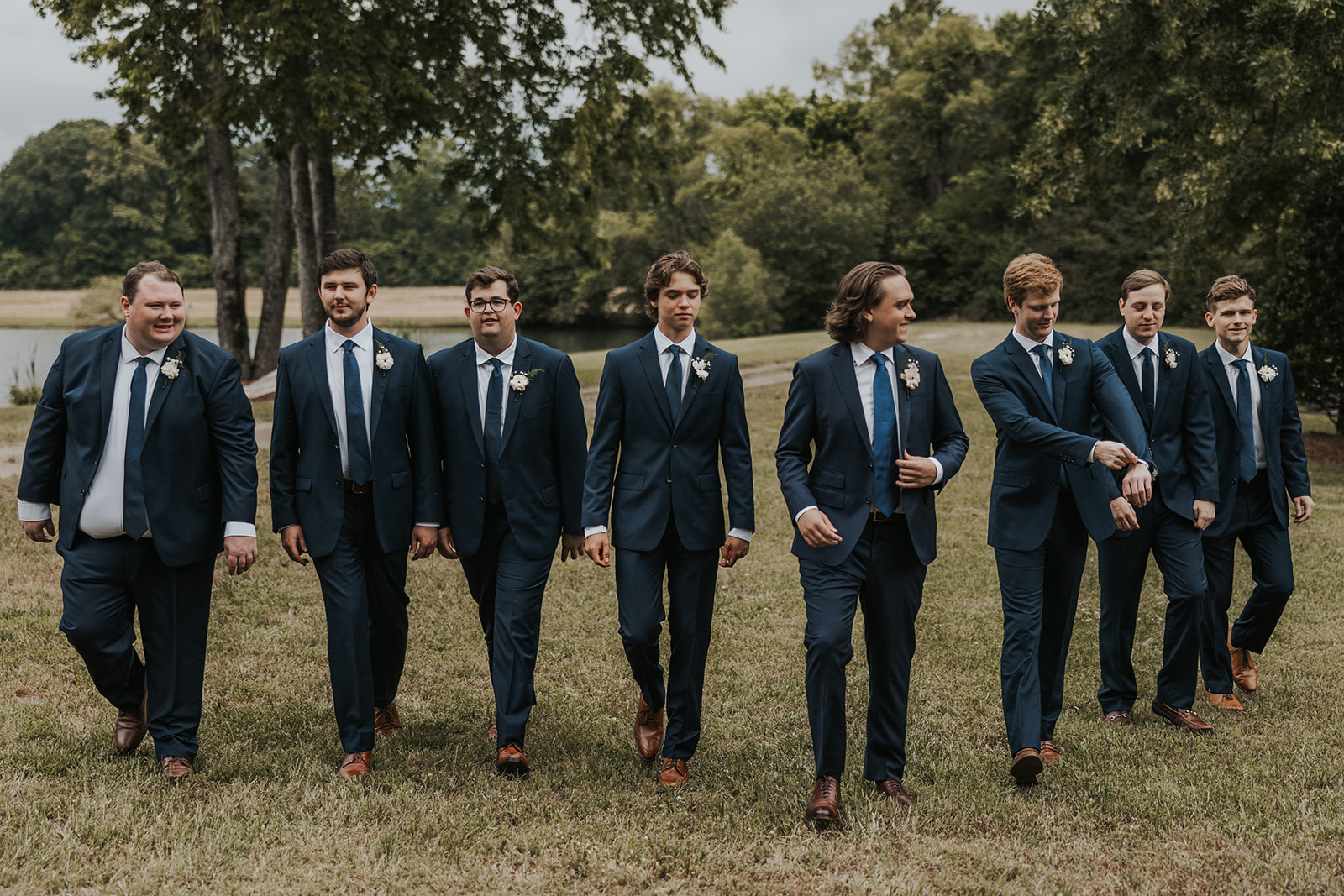 groom poses with his groomsmen 