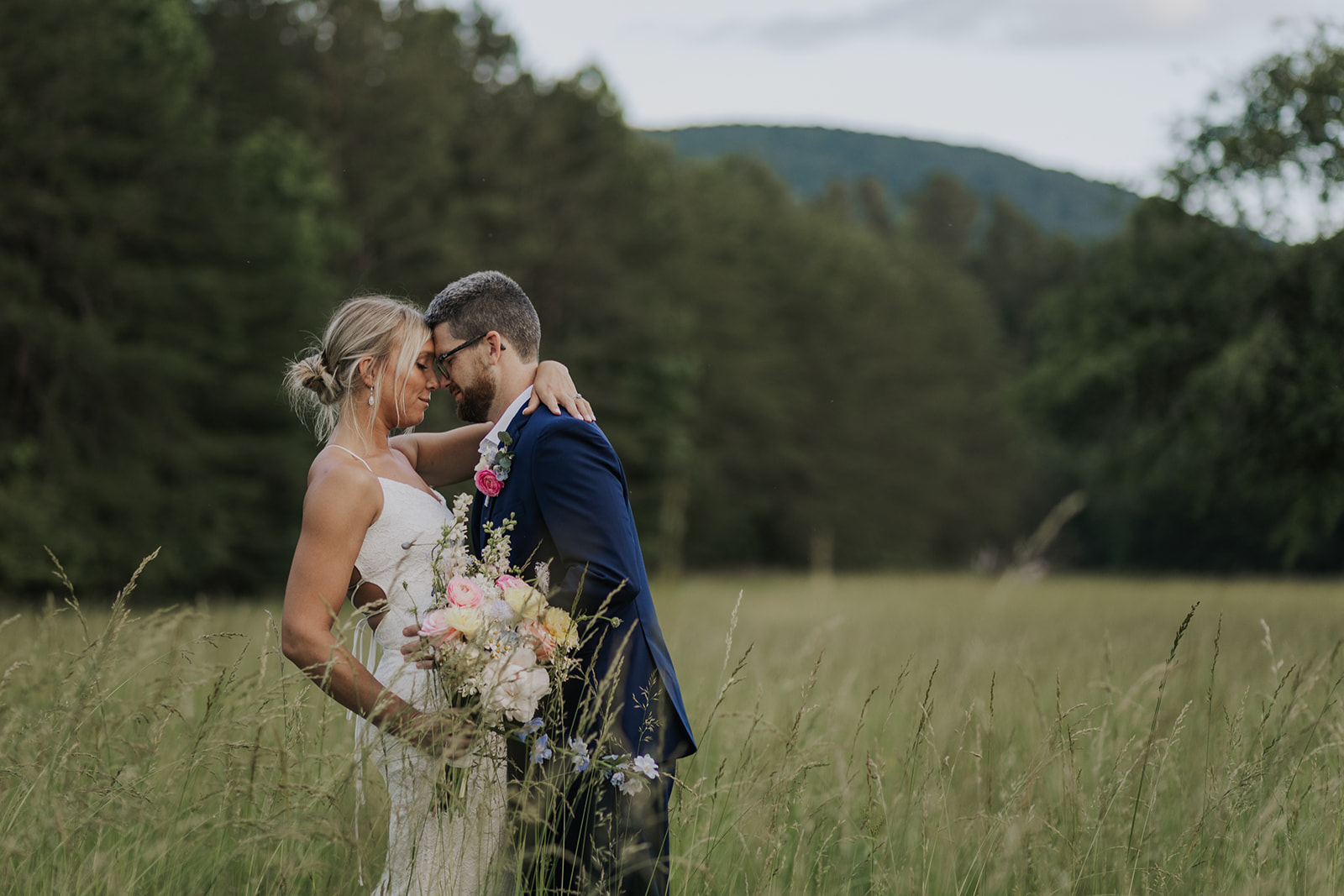 Stunning couple pose together in a wild Georgia field