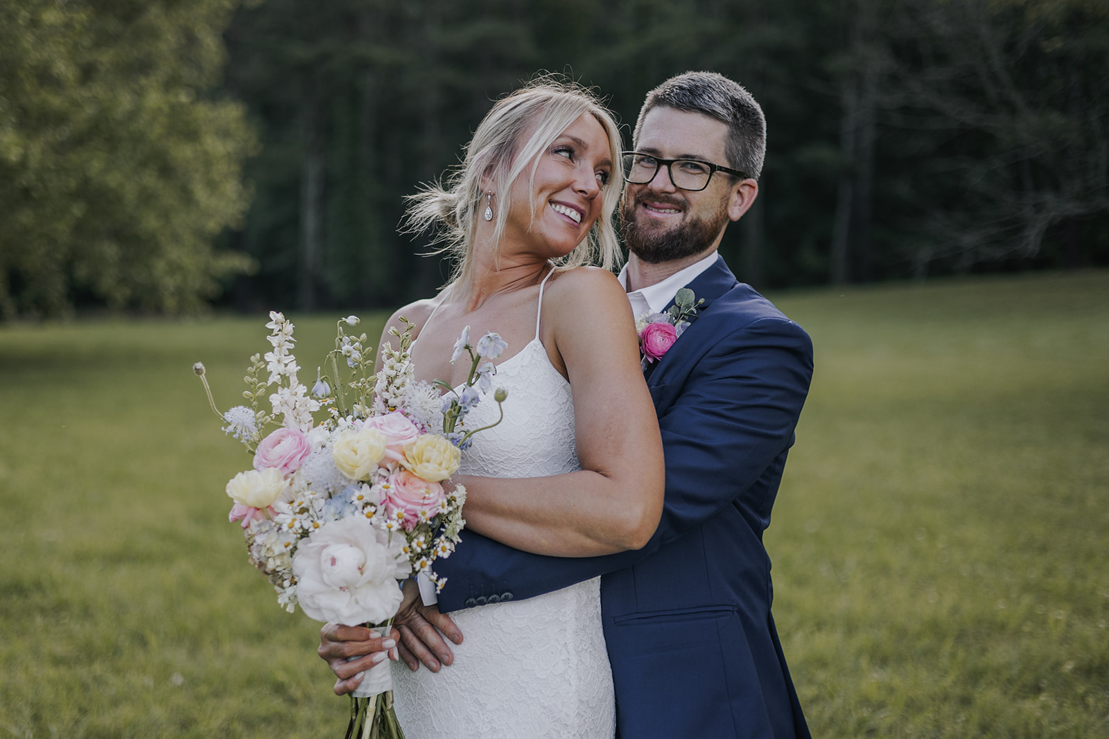 Stunning couple pose together in a wild Georgia field