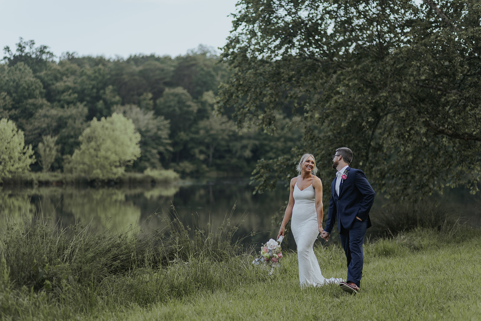 Stunning couple pose together beside a serene Georgia pond